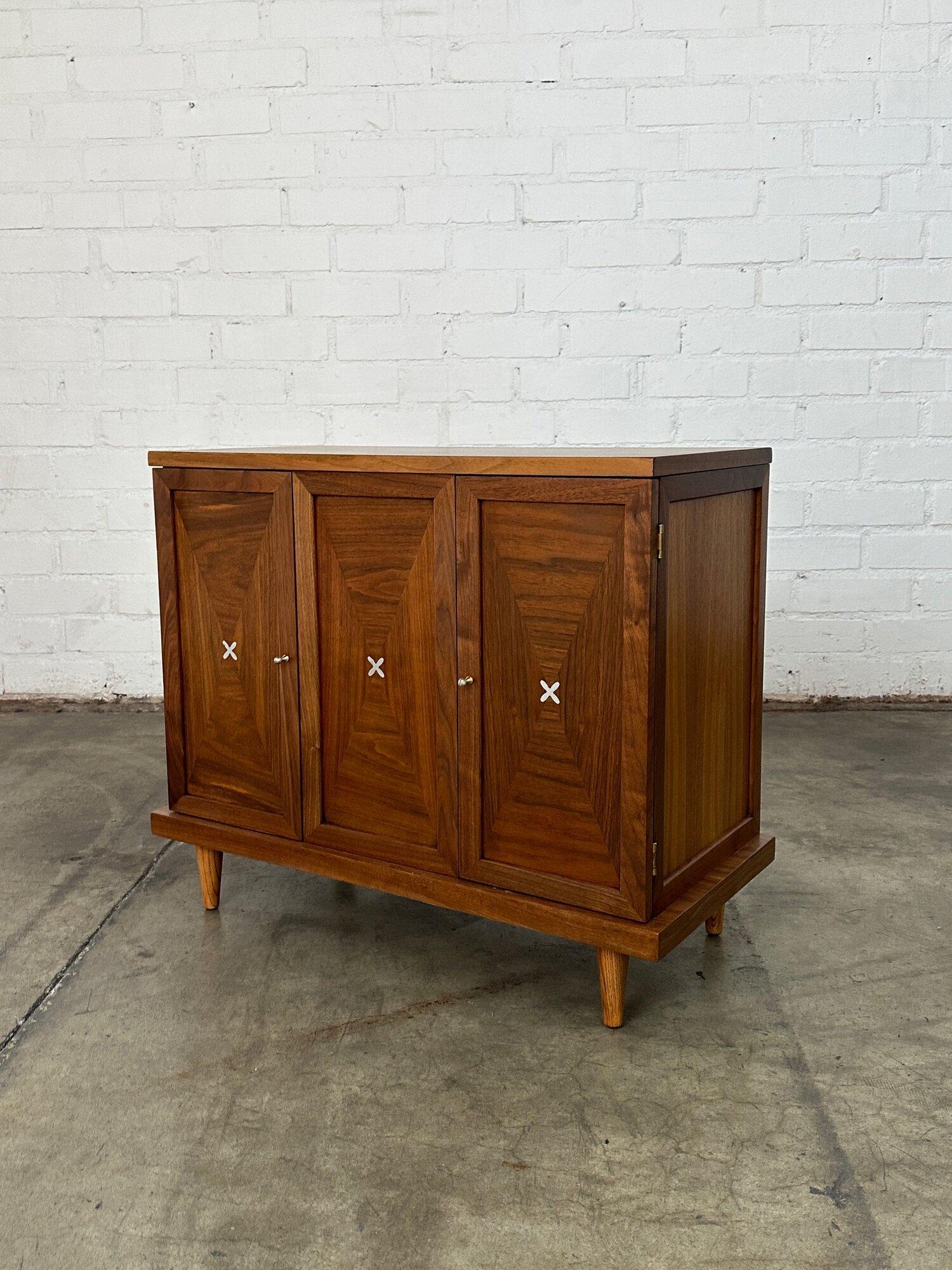 W31 D14.75 H26.5

Space under shelf H15

Compact credenza in fully restored conditon. Item features inliad aluminum,  contrasting grain, and orginal hardware. Item is structurally sound and fully functional.