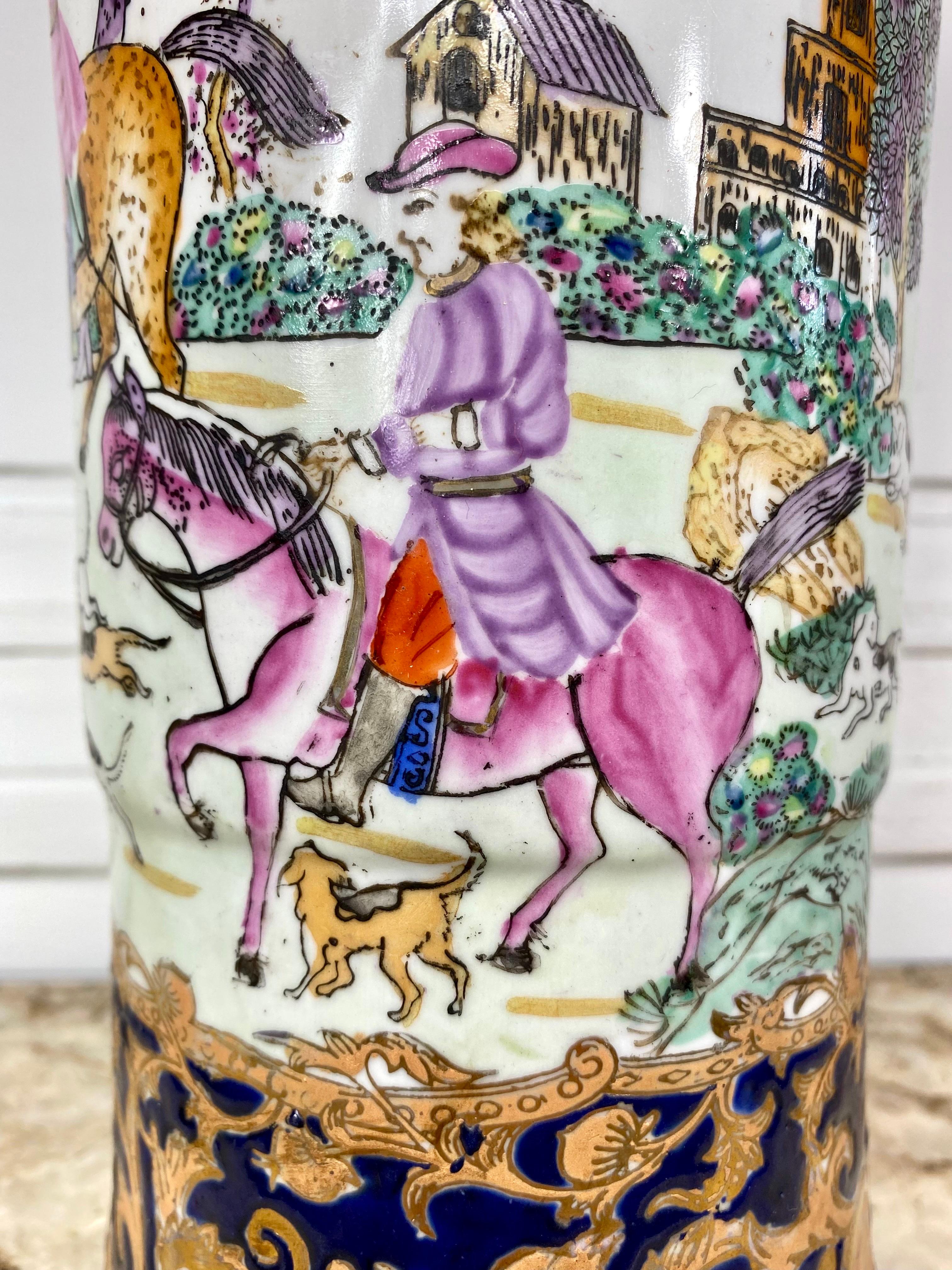 Large Chinese porcelain cornet vase decorated with a court hunting scene representing three men on horseback, one of them holding a hunting horn, the pack of dogs running at the foot of the horses. In the background, a city, probably Flemish since