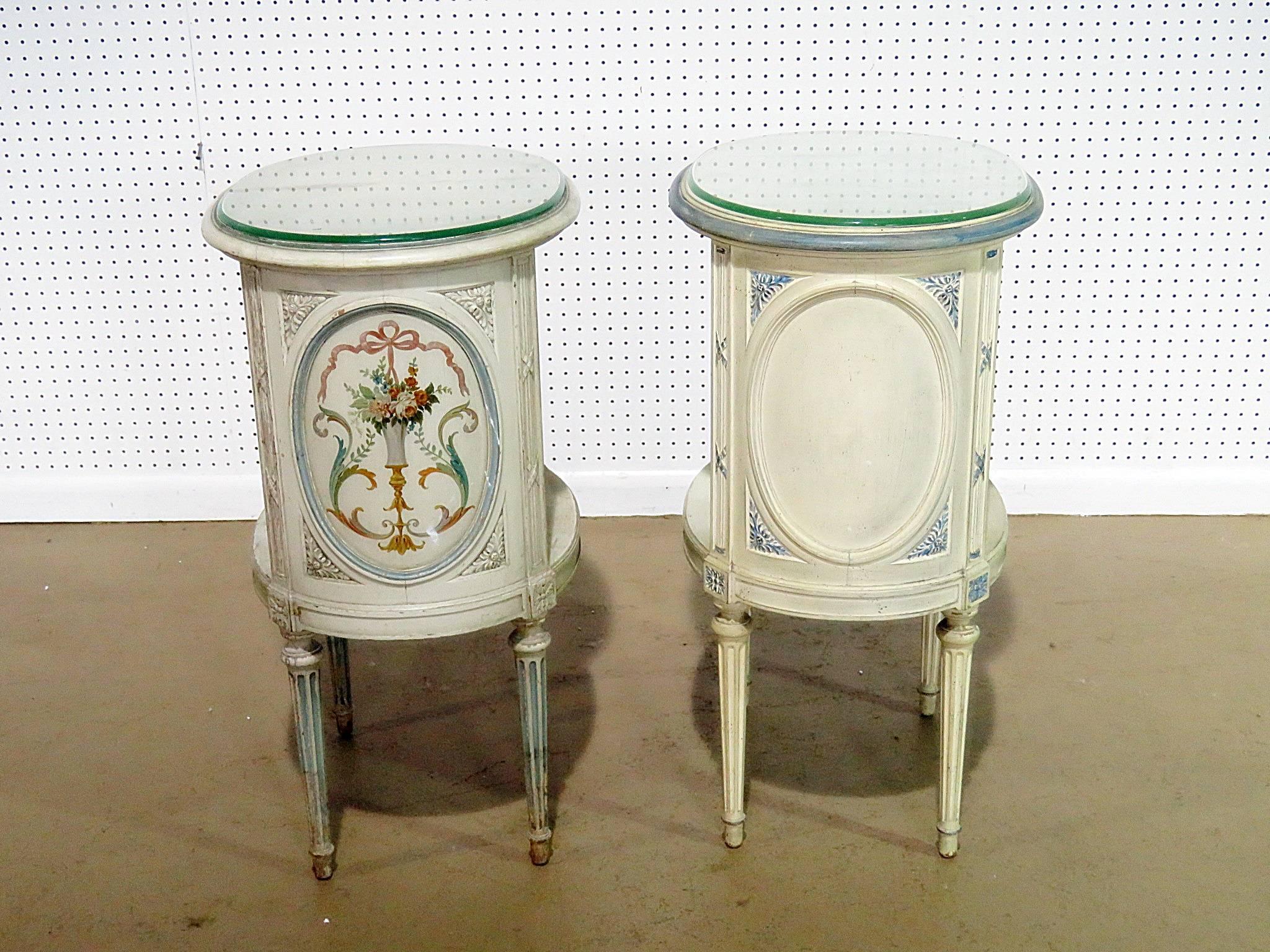 Companion pair of Swedish Louis XVI style distressed painted two-tier nightstands with glass tops.