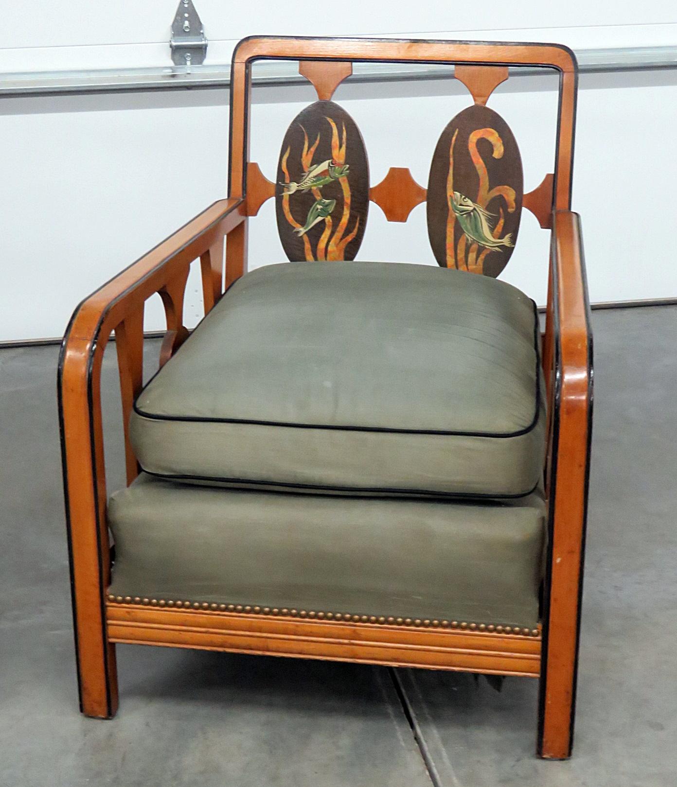Companion pair of Art Deco armchairs, with a painted fish design, ebonized accents, and nailhead trim. One chair measures 38