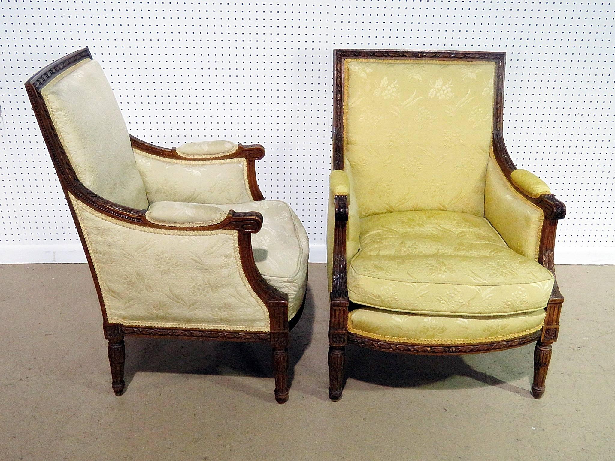 Companion pair of Louis XVI style bergeres attributed to Jansen.