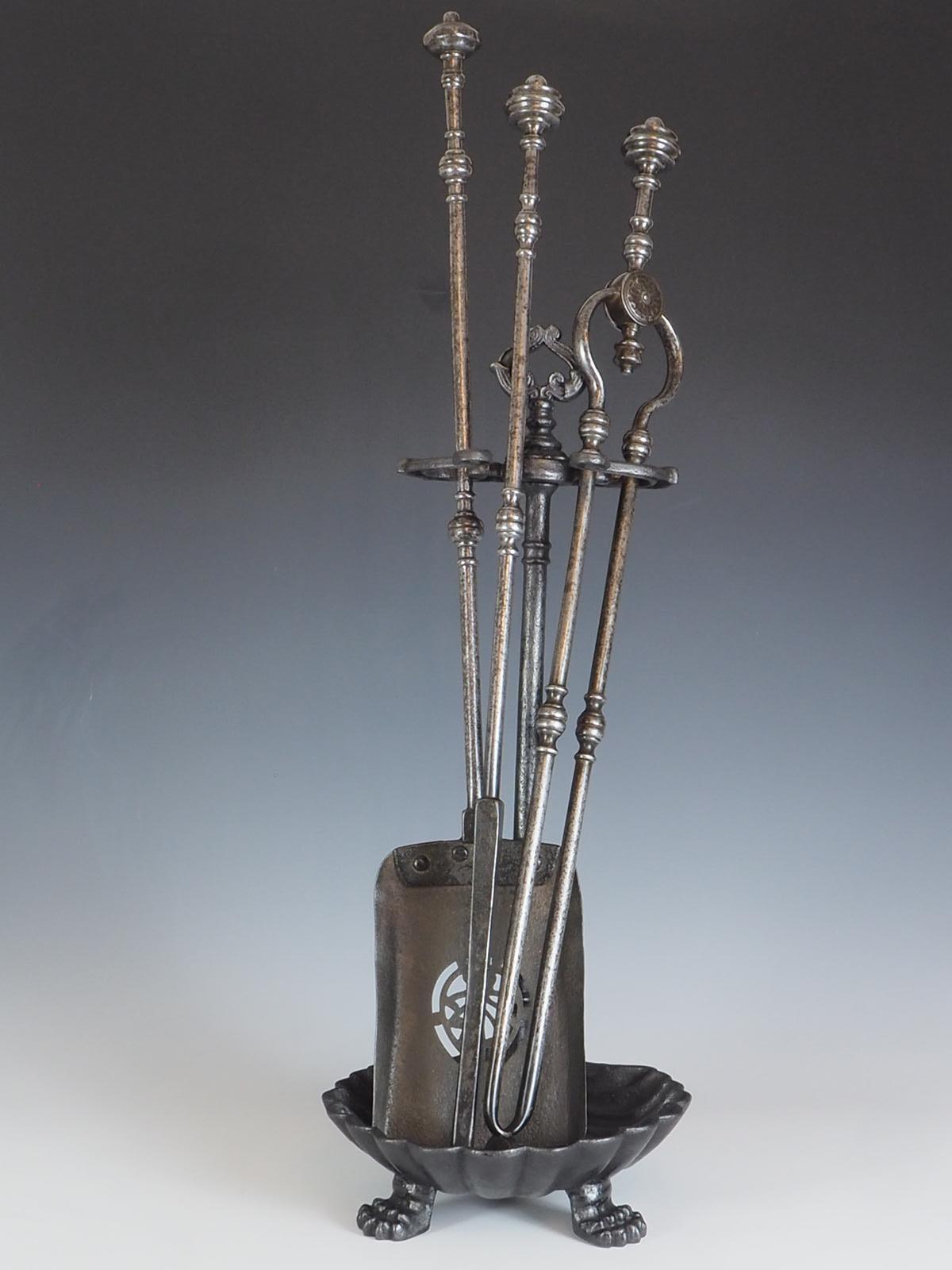 Companion set of three George III steel fire tools is a true masterpiece of craftsmanship from the early 19th century. The set includes a lovely pierced shovel, tongs, and poker, each with capped and knopped finials and banded shafts.

The pierced