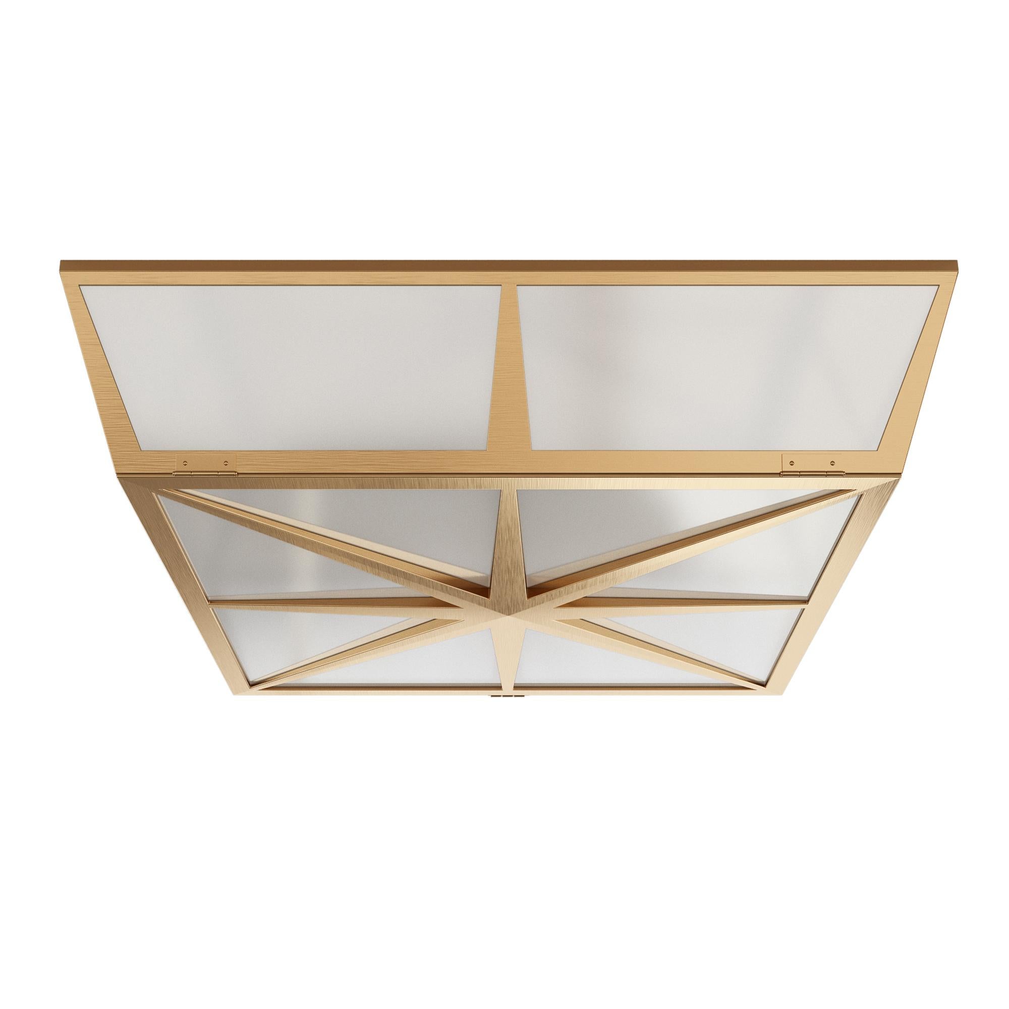 A square flush mount designed by David Duncan. This flush mount light fixture features a lightly antiqued brass patina, subtle, tapered sides and white opal acrylic diffusers. A raised, star compass motif is illustrated on the underside. A hinge and