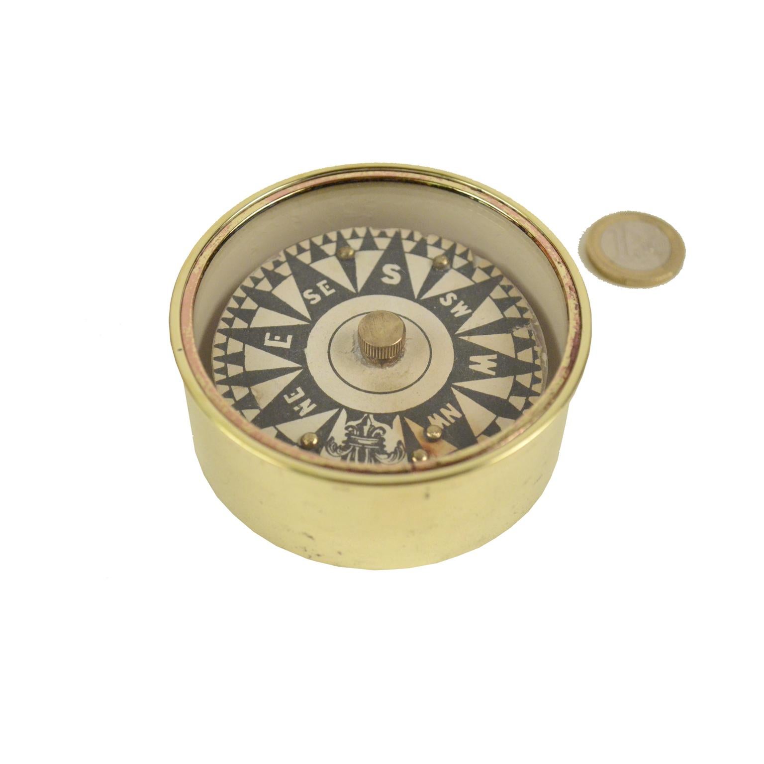 Dry compass placed in its original turned brass box with a protection glass. English manufacture of the mid-19th century. Compass card printed by engraving on copper plate. Very good condition and fully functional. Measures: Diameter 8 cm, height cm