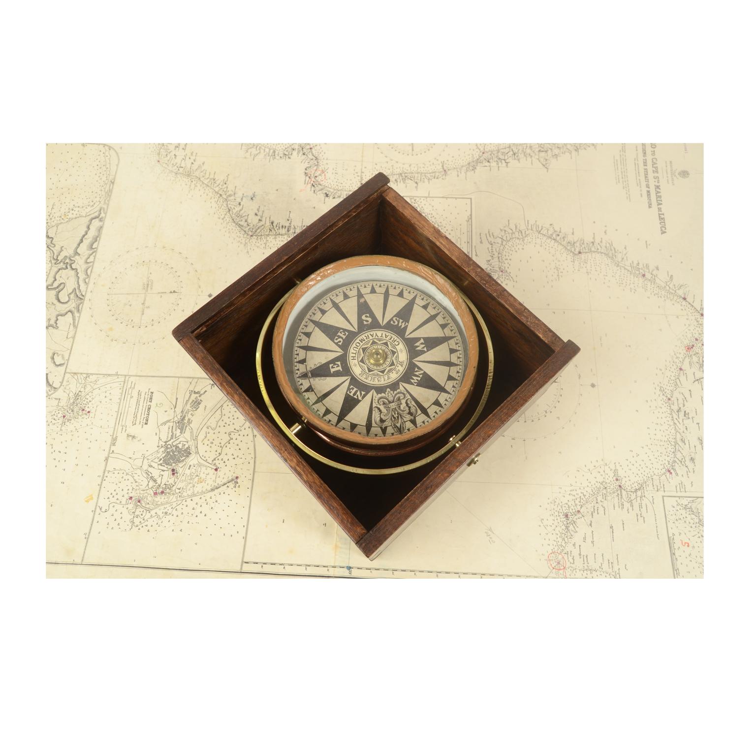 Compass in its original wooden box with slot lid. Signed W. T. FISHER Great Yarmouth, mid 19th century. The compass is made up of a copper container with a lead and glass counterweight on the bottom of which is fixed a metal stem on which the eight