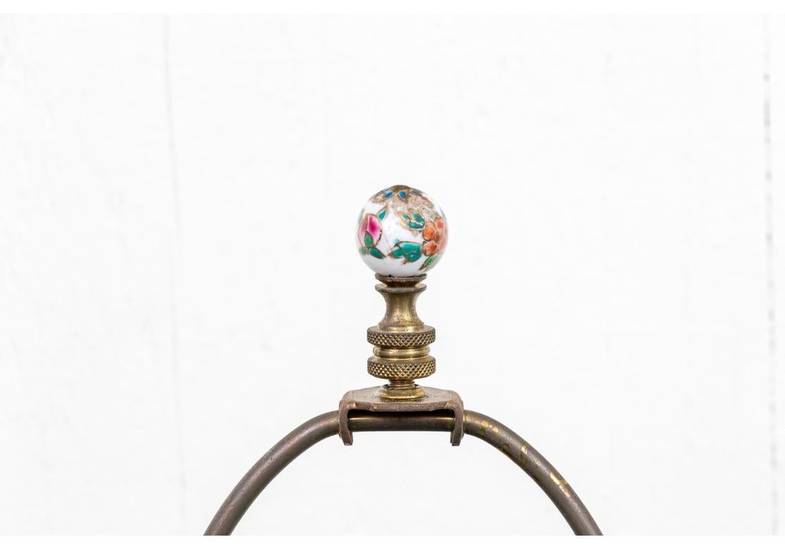 A fine pair of Floral Painted lamps with Swirling Jar form and mounted on hexagonal black lacquered bases. Top round finials also with floral decoration. The two bases are slightly different but work well together as compatible. 

Dimensions: 25”