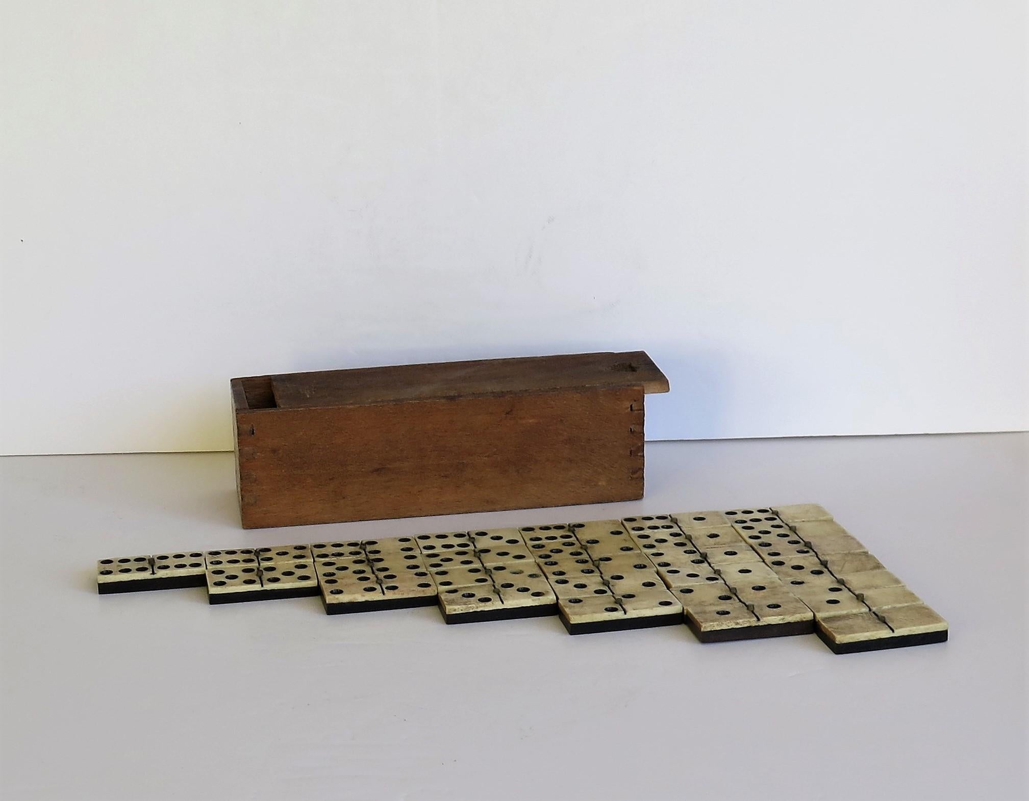 This is an original and complete Domino game, coming with its own jointed wooden storage box with a sliding lid, all dating to Victorian England, circa 1870.

Dominoes is a classic game of strategy and fun to play for all age groups. This set has