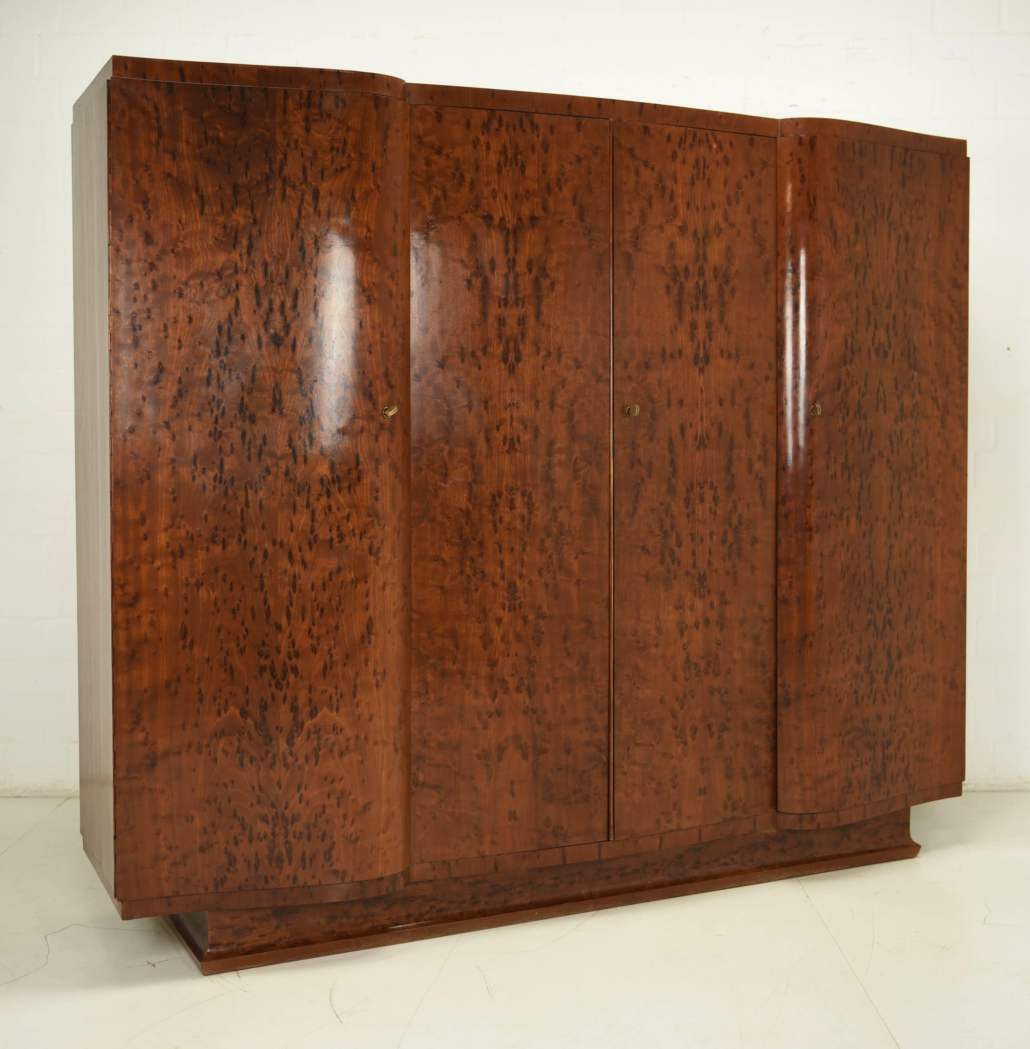 A complete Art Deco bedroom set from, circa 1930. Everything is held in a brown, extraordinary rootwood veneer with an astonishing grain. Great black points accentuate the veneer and create a wonderful wood atmosphere. The fittings and locks are