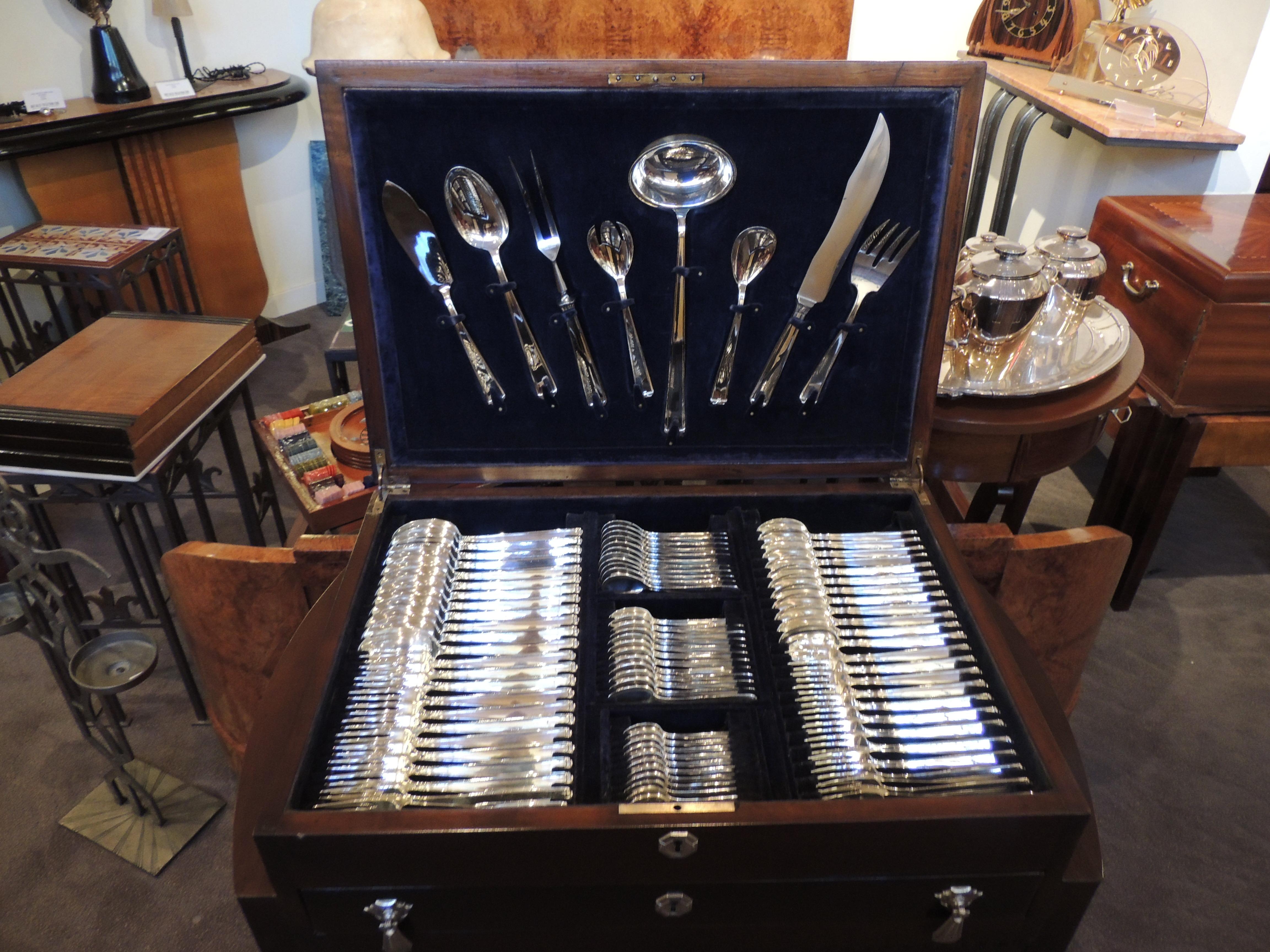 A complete set of silver service for 12 in an Art Deco Cabinet from the famous silversmiths at Plata Lappas. Nothing is as elegant as heavily plated silverware in fitted drawers of a custom cabinet designed to hold each piece. Argentine in origin