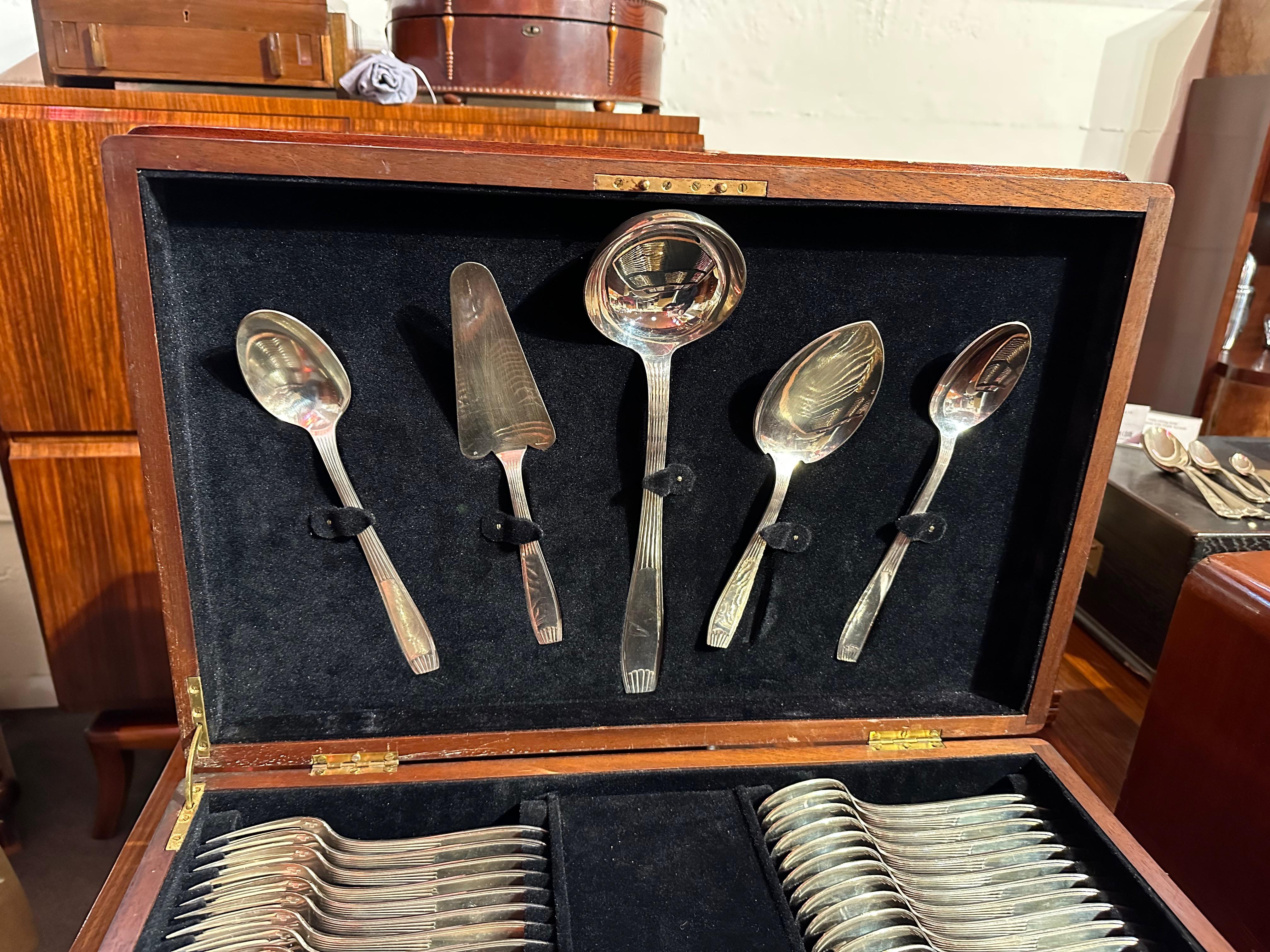 A set of  Christofle silverware in a complete service for 12 in a velvet-lined fitted chest. This is the modernist “Cirta” Pattern with 125 Pieces in all. Each piece is nestled in its own compartment with the five beautiful serving pieces displayed