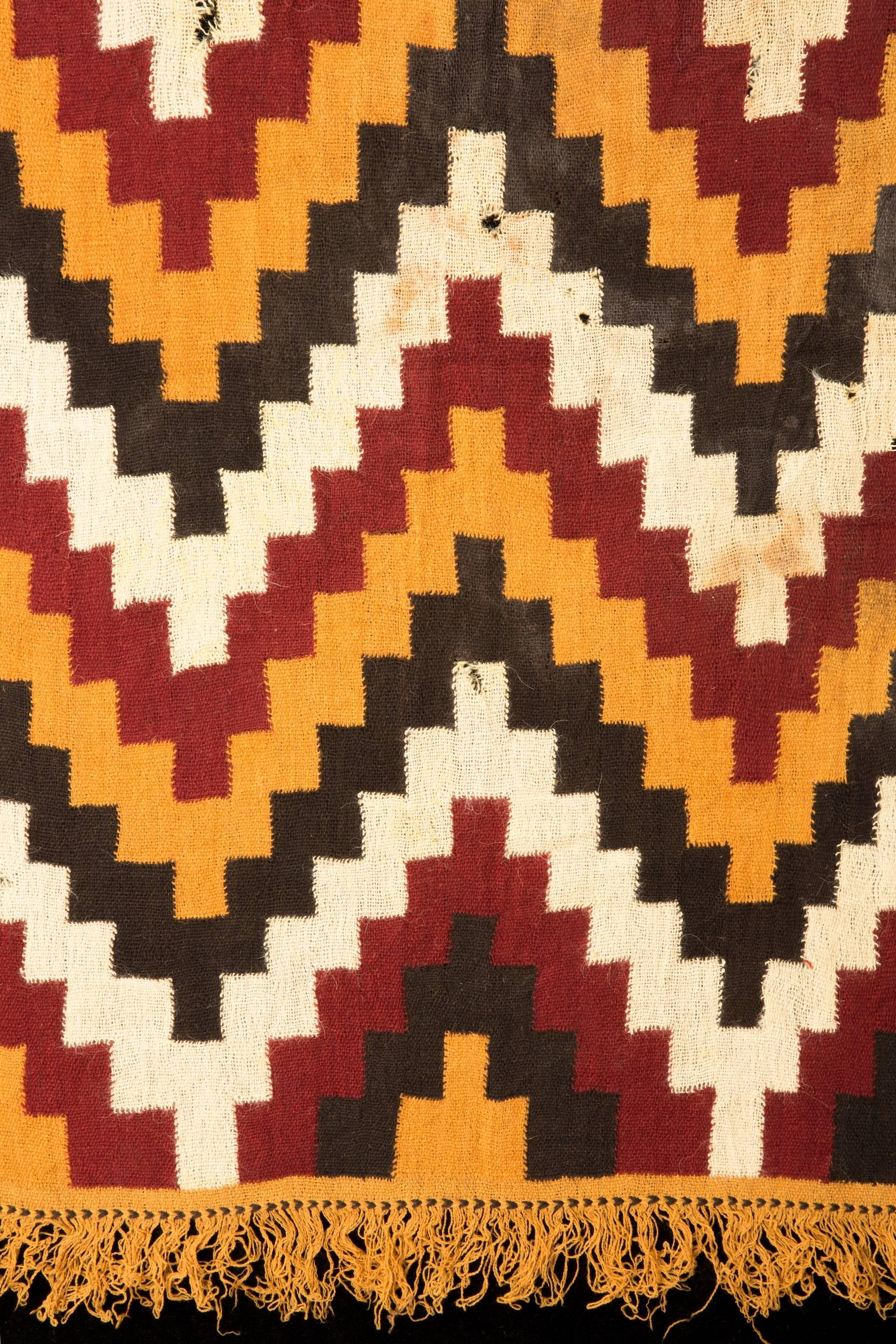 Complete textile panel with zig-zag patterns in white, yellow red and black or brown shades.
