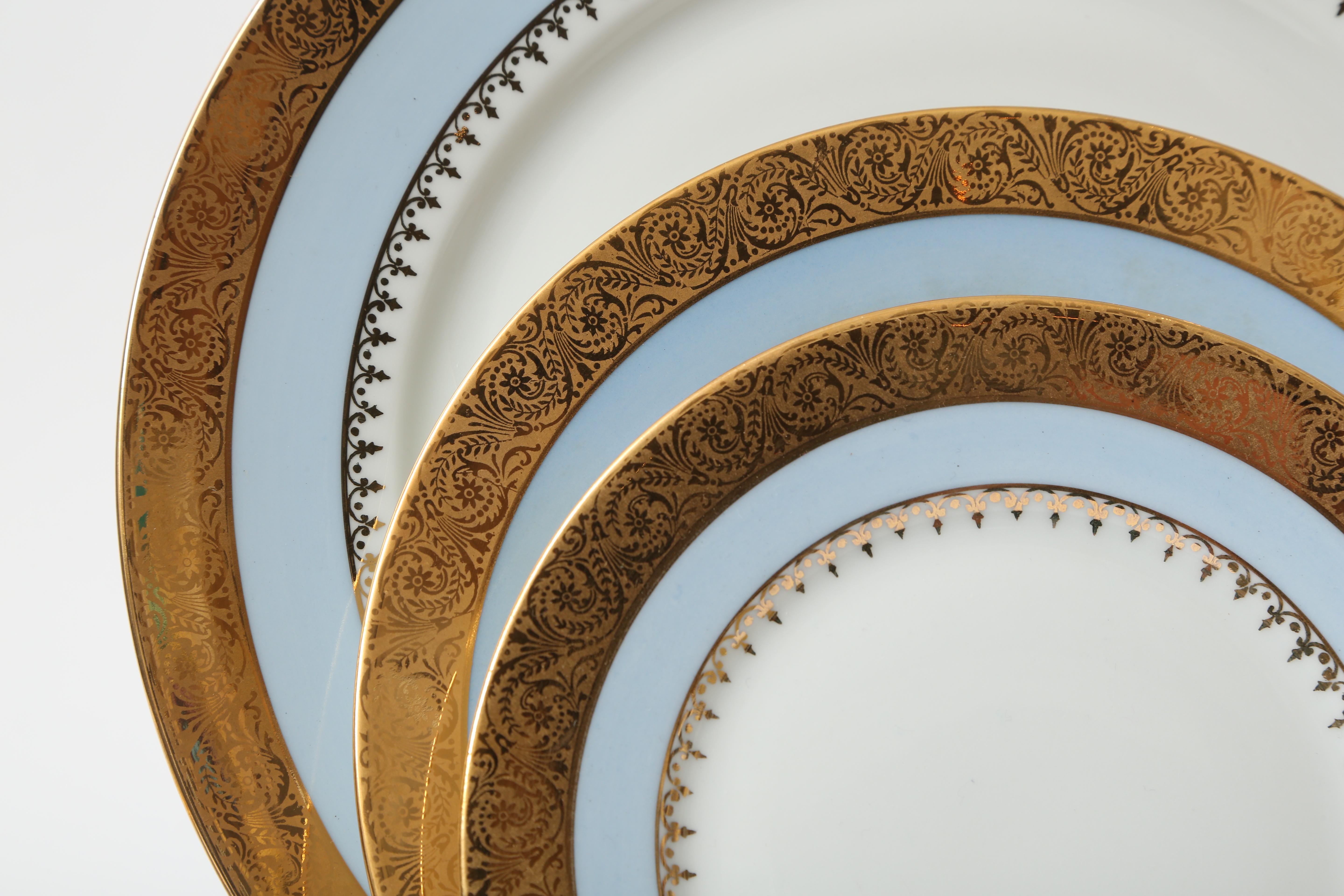 An elegant and complete vintage service from the storied Limoges France firm of Charles Field Haviland. In virtually unused condition, this set still had all its original paper packing. With an acid etched 24-karat gilt band and hand colored