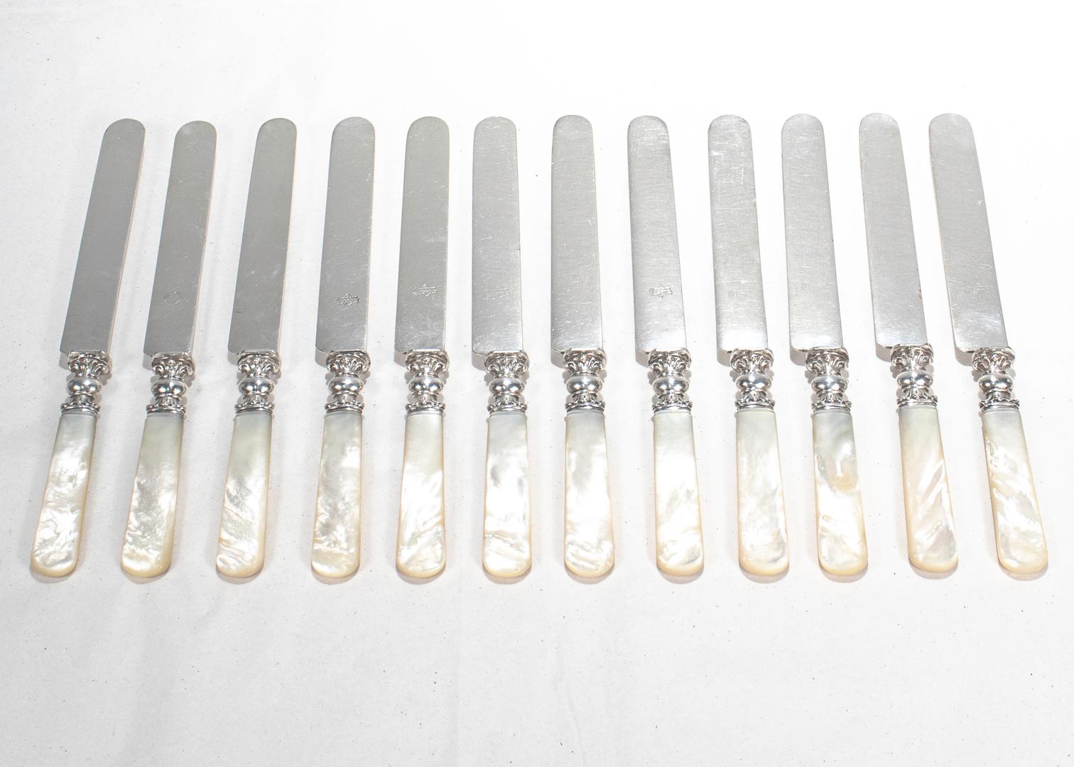 A complete set of 12 mother of pearl knives.

A real rarity in the full dinner knife size.

Each with a silver-plated blade, solid carved mother of pearl handle, and a sterling silver ferrules. 

These knives are simply well crafted and of