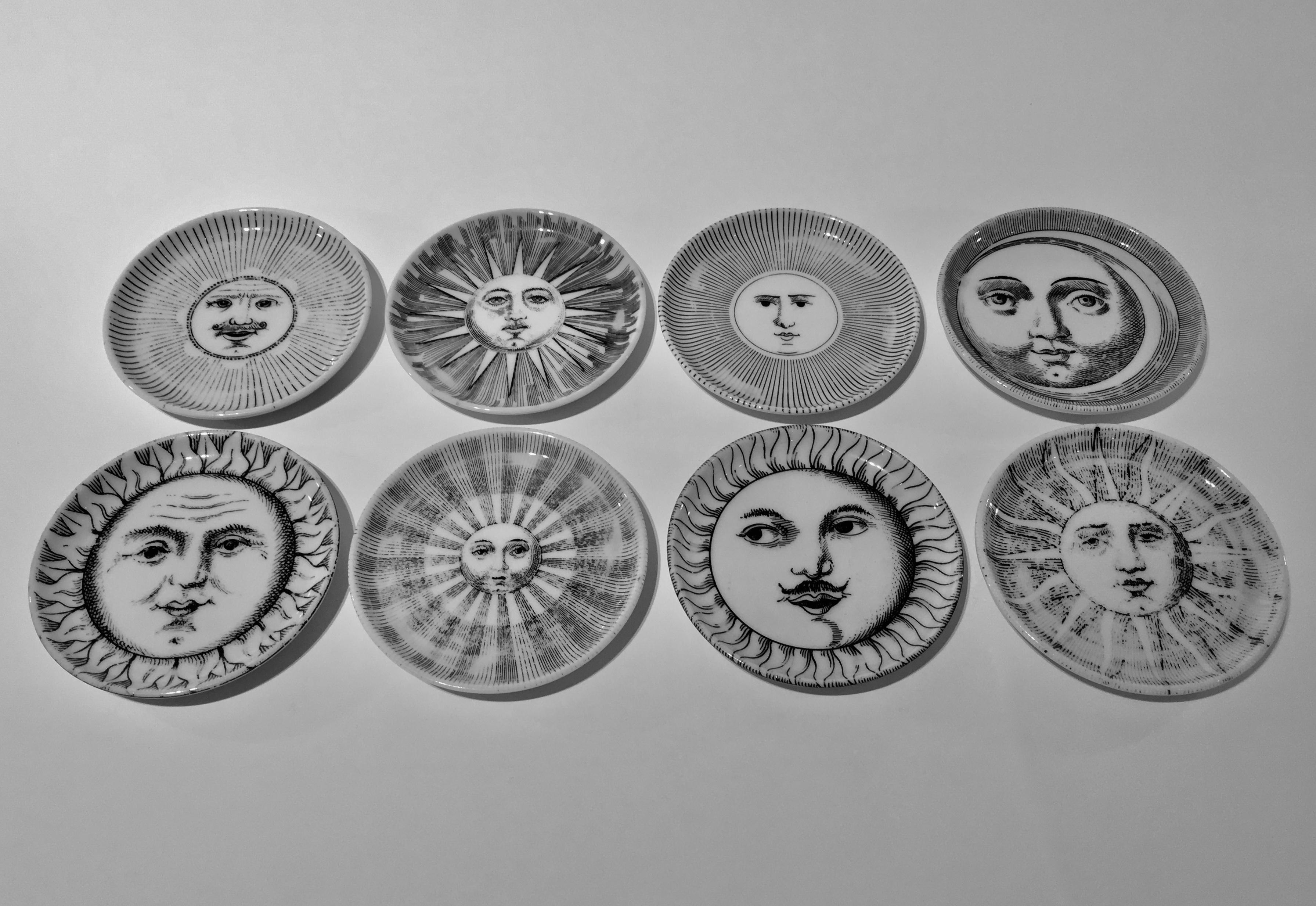 A complete set of 1960s ceramic drinks coasters designed by Piero Fornasetti, Italy, circa 1960. This design, titled 'Soli e Lune' or Sun and Moon is one of Piero's most popular and striking motifs and depicts eight faces... four solar and four