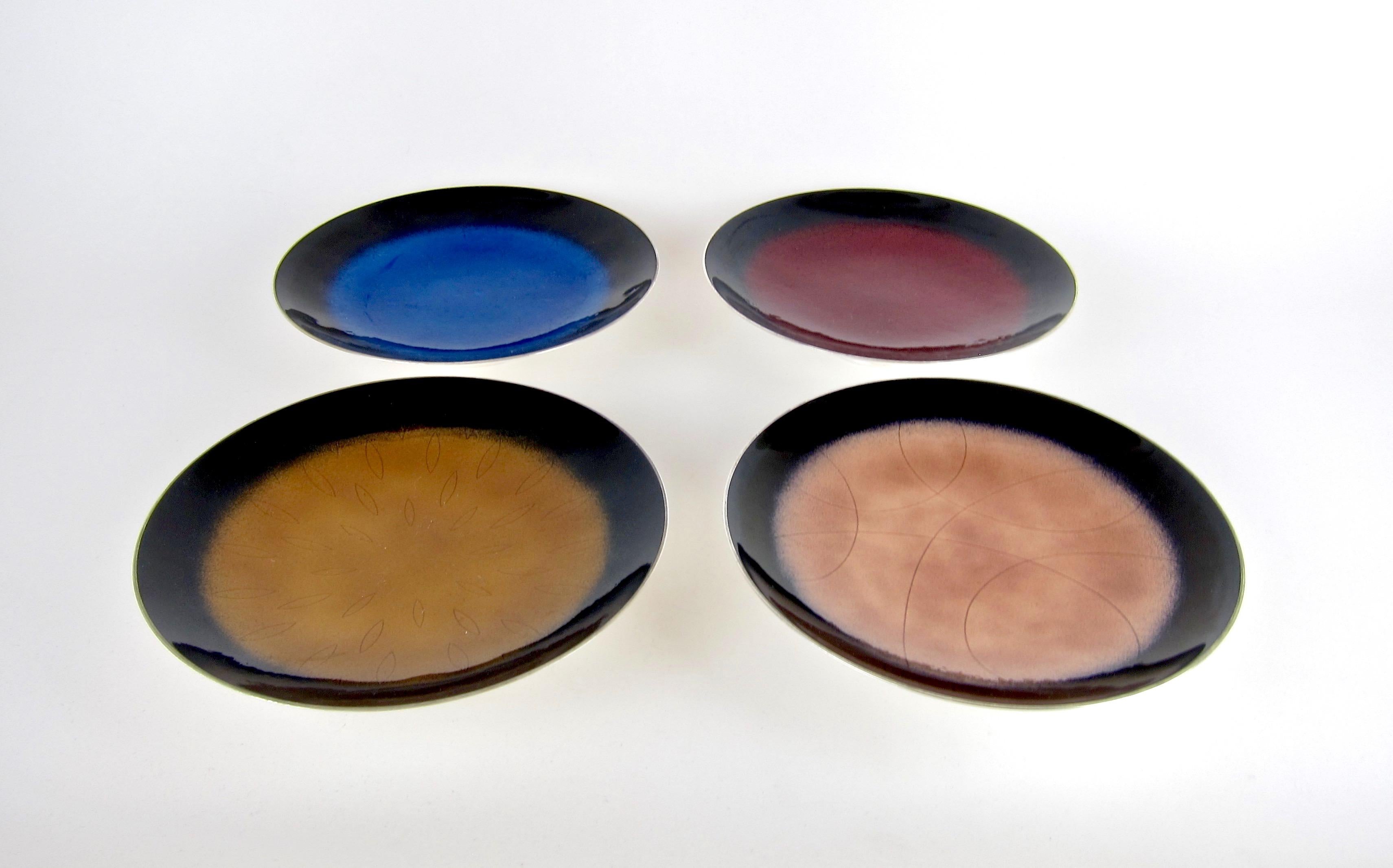 A complete set of four Mid-Century Modern enameled tazzas (a shallow dish with a short foot) in silver plate from Towle silversmiths of Newburyport, Massachusetts, designed circa 1955. The pieces are illustrated as a set in Jewel Stern's