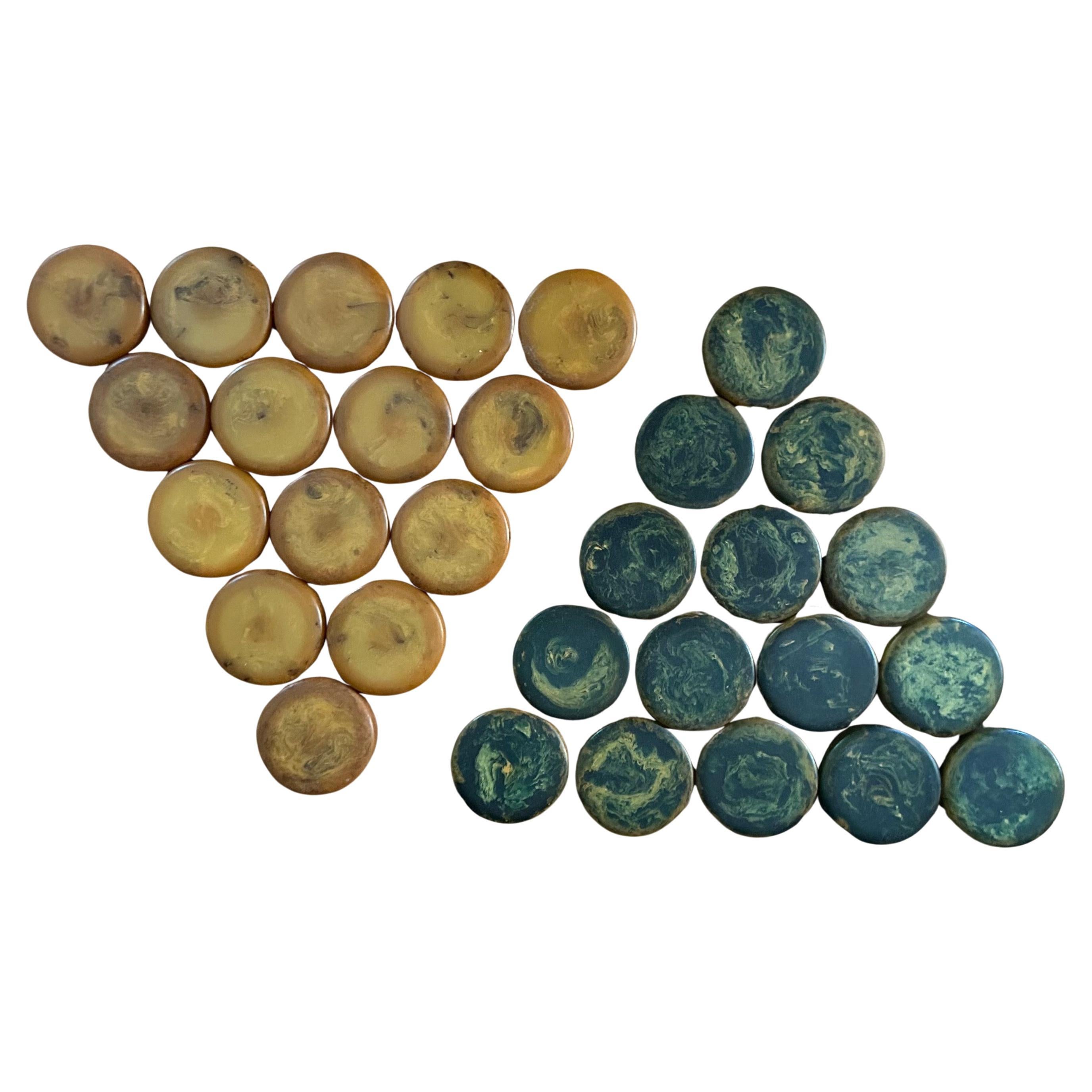 Gorgeous and very hard to find complete set of thirty vintage large bakelite yellow and blue backgammon checkers, circa 1930s.  The set is in very good vintage condition with a fabulous patina; each checker measures a substantial 1.75