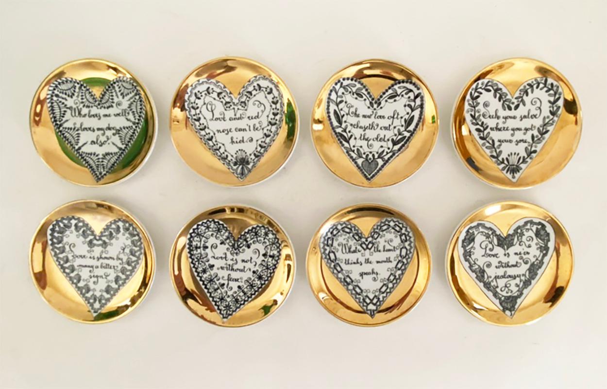 Here is a very nice set of vintage LOVE coasters by the great Piero Fornasetti from the 1950s. There are eight coasters, each with a different phrase on the subject of love. 

The coasters are in very good condition--the gold is bright with no thin