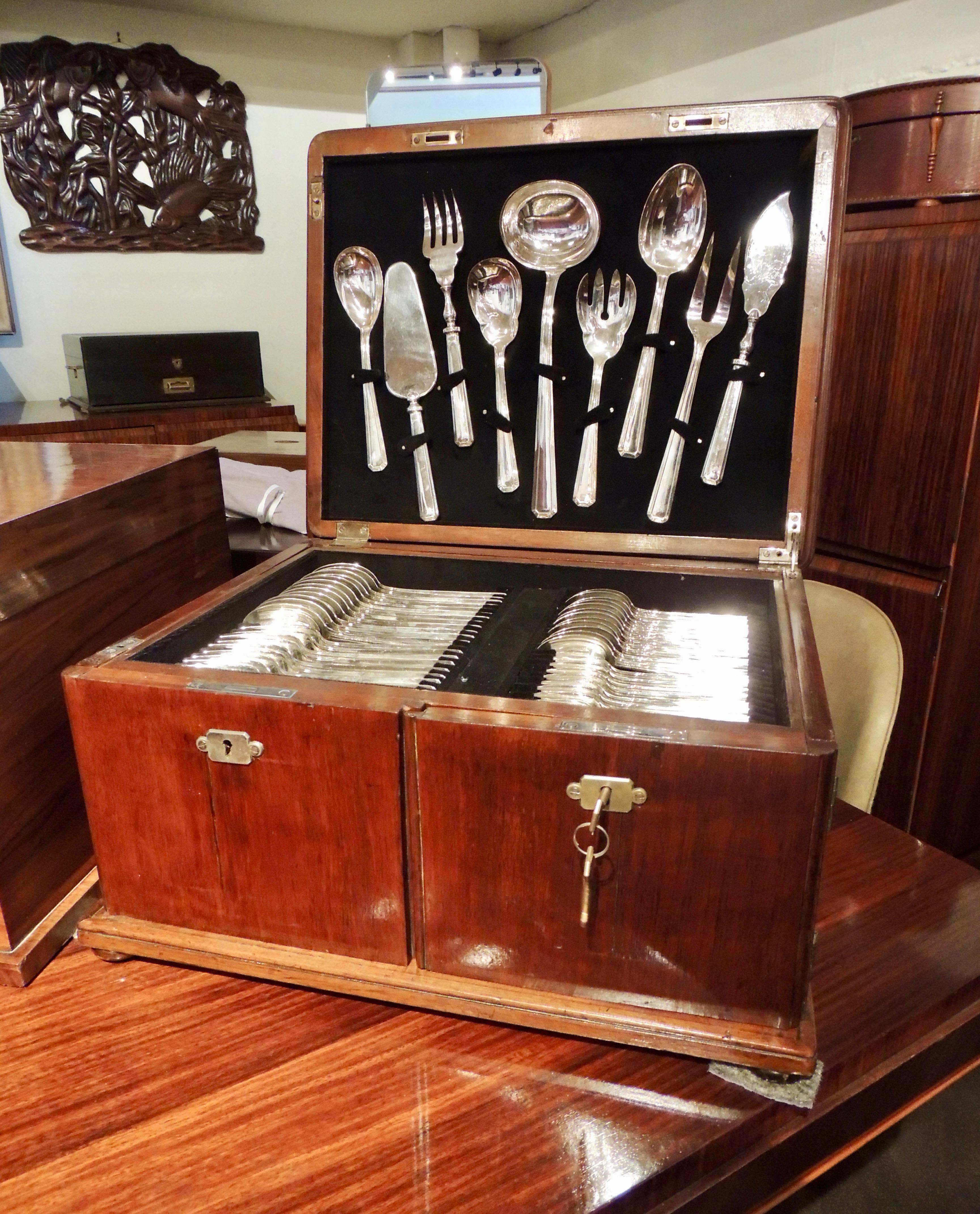 Complete twelve-piece silver service for twelve in beautiful condition from Calderoni Fratelli of Milan Italy. The set contains a total of 153 pieces and all of it housed in a custom wooden chest with felt-covered fittings to hold each piece in