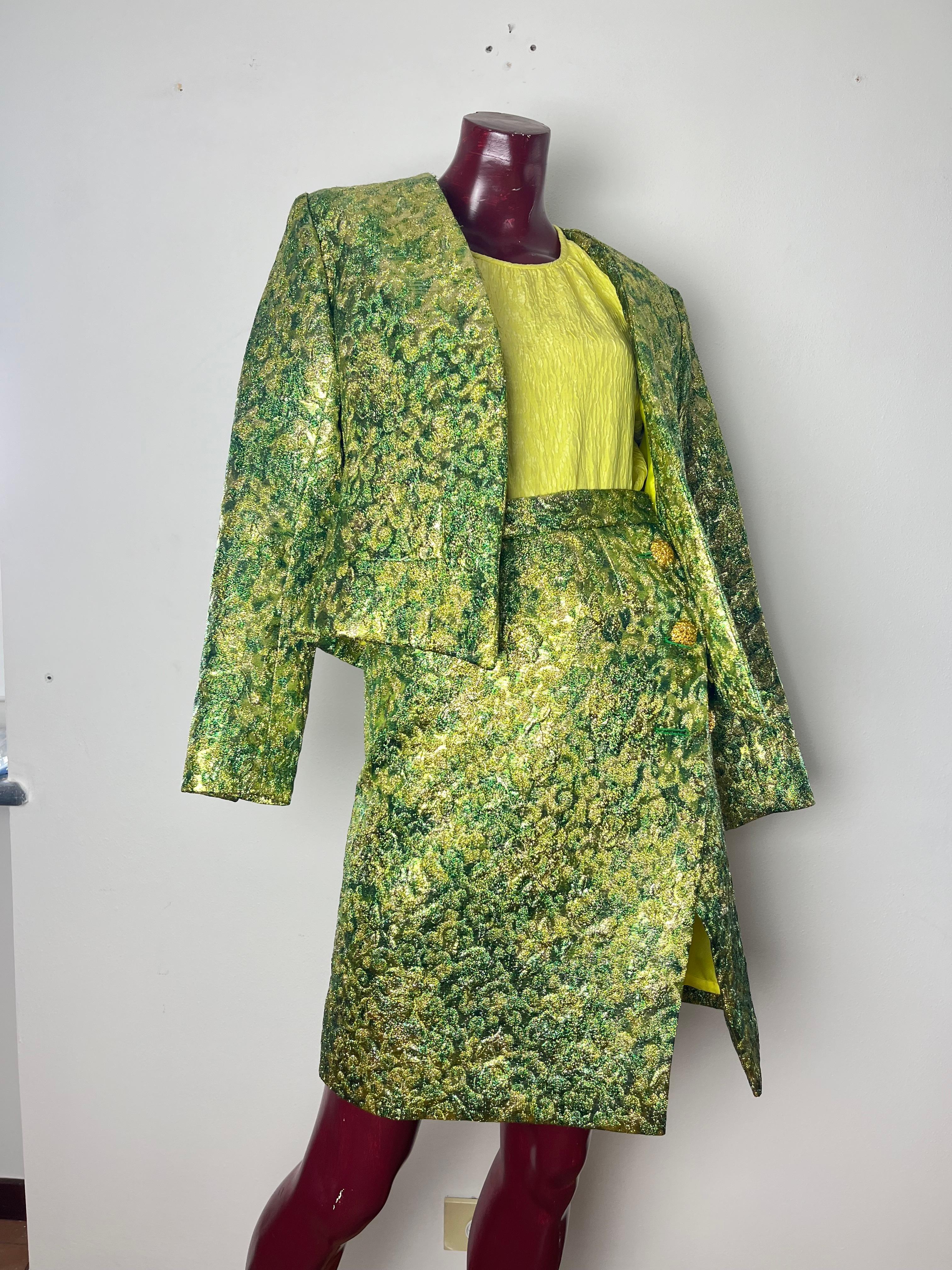 Yves saint laurent rive gauche , jacket and skirt set with matching shirt 

the short blazer over the hips without buttoning and spikes on the front in green/yellow brocade fabric with two gold jeweled buttons on the cuffs

the high-waisted
