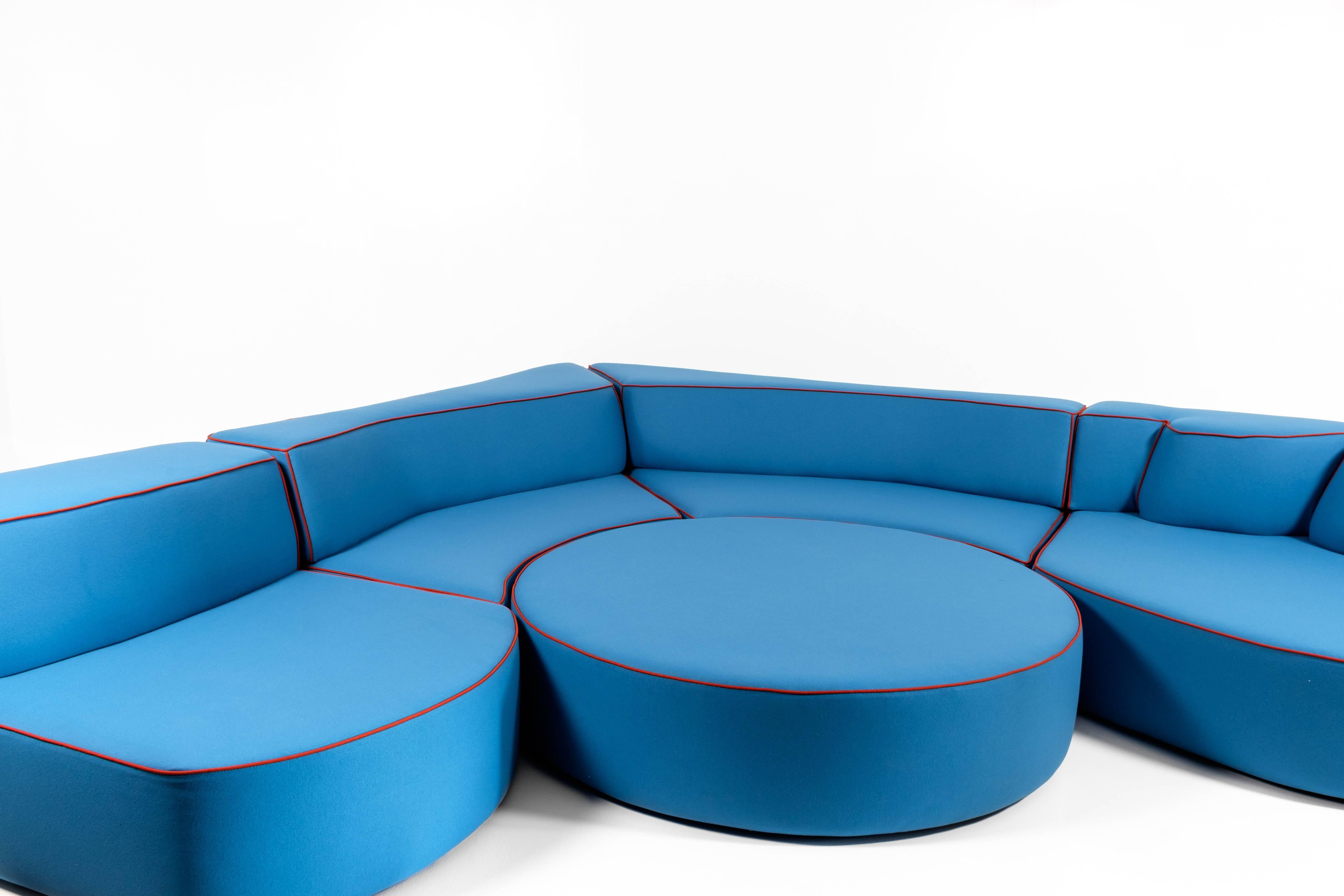 JPDemeyer Home Collection five-piece modular sofa “Comporta” in Azure colour wool.
Funky, off-the-wall modular five-piece island sofa in a polyurethane foam structure. Central ottoman piece can be used as a coffee table or as foot rest pouf. Based