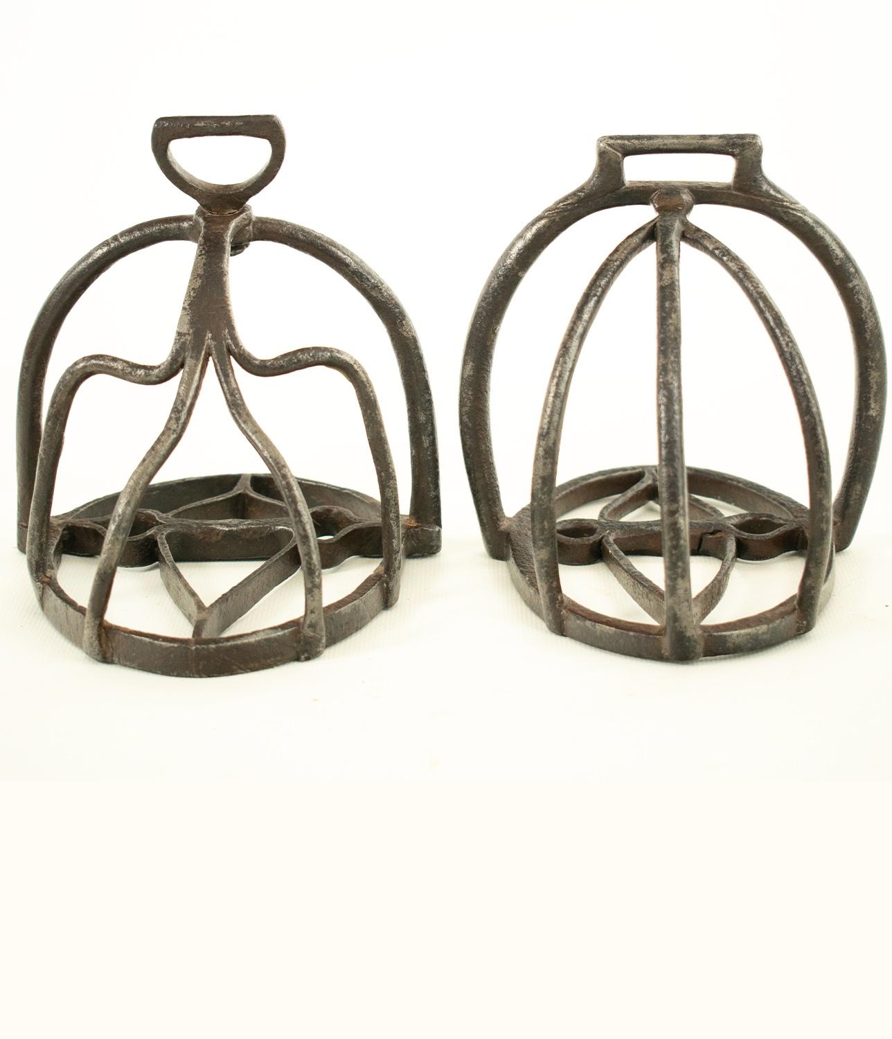 An interesting composed pair of original mid 17th/early 18th century cage or basket Stirrups.

Superbly hand forged and of the period in wrought iron with openwork branches and foot plate, one with a rotating attachment eye, good general condition