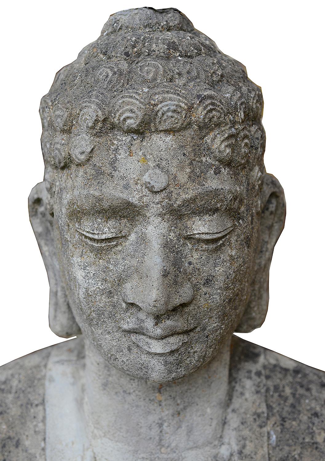A decorative early 20th century composition stone standing Tibetan Buddha.