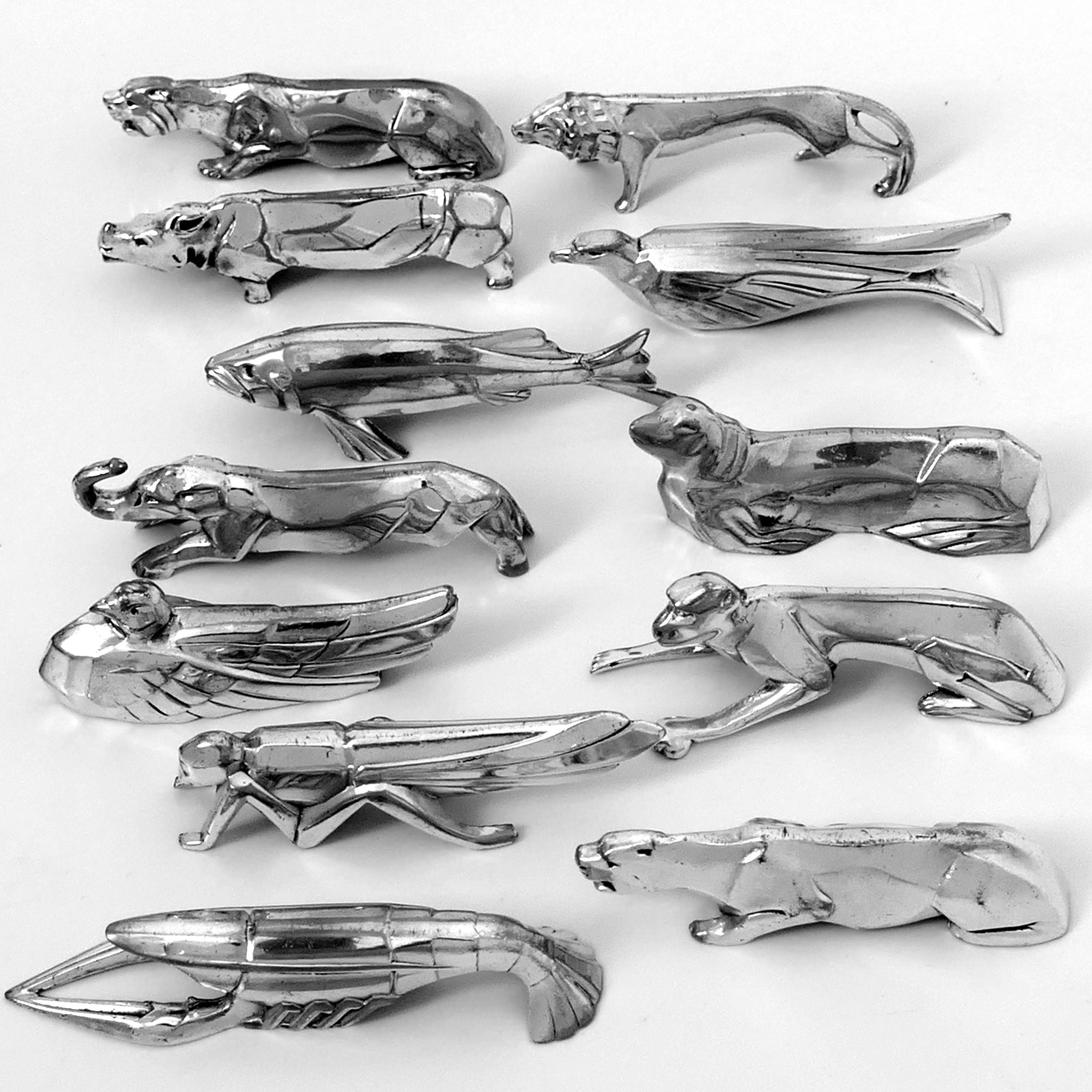 Rare set of twelve chrome plated metal knife-rests in the shape of different animals: lobster, lion, grasshopper, elephant, hippopotamus, monkey, eagle, fish, sea lion, puma (2) and duck, circa 1920-1930. 

The knife rests feature the characteristic