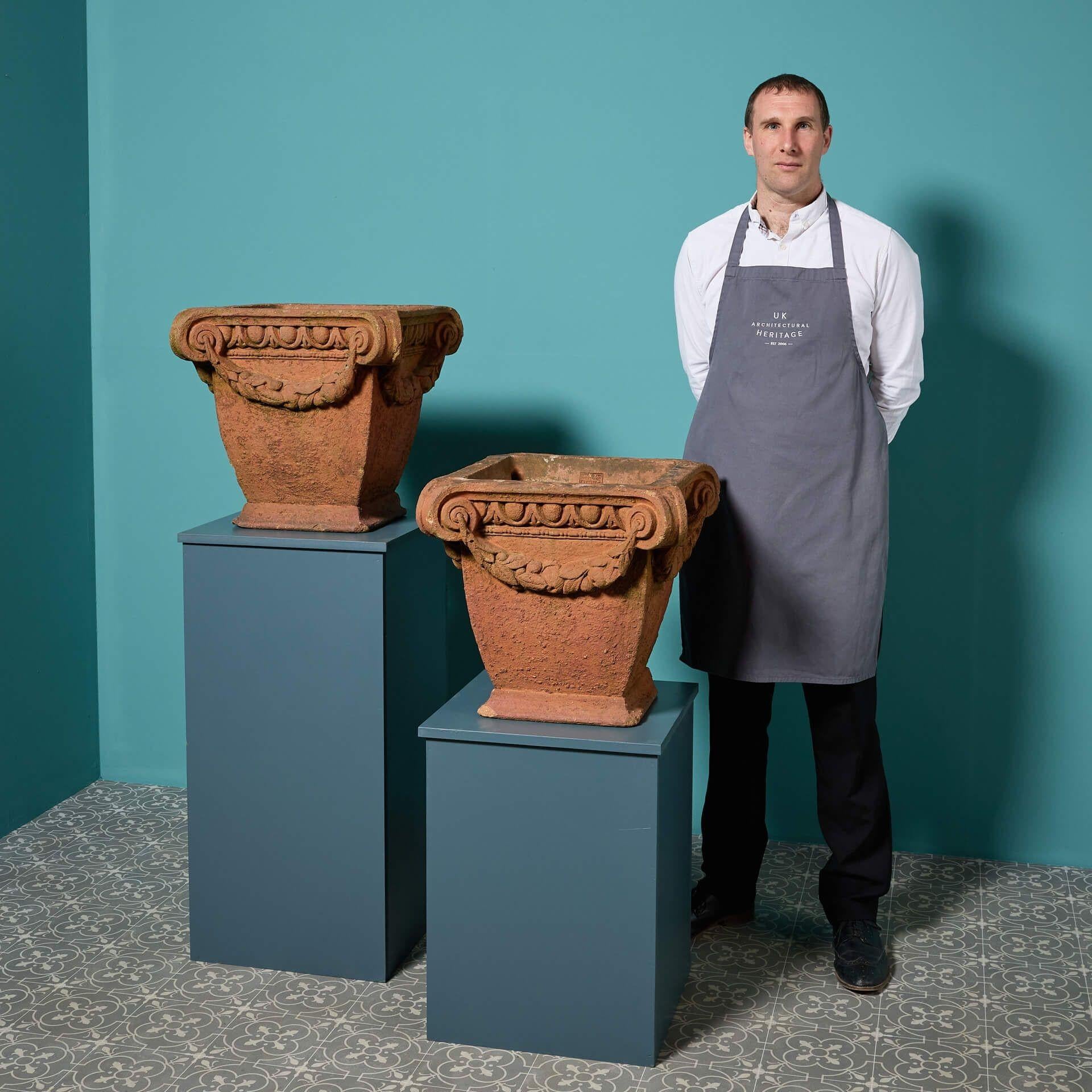 A matching pair of antique neoclassical style terracotta pots, stamped Liberty & Co and attributed to Compton Pottery.

Dating from the early 20th century, these reclaimed terracotta planters are handcrafted to a matching neoclassical style design,
