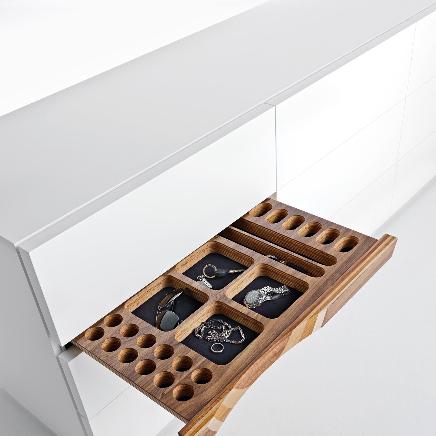 Simple yet elegant, this cupboard is enriched by a front insert recalling Toyo Ito’s famous Ripples Bench, combining walnut wood with oak, mahogany, ash, and cherry hiding a small jewelry drawer. The Minimalist design features a frame of