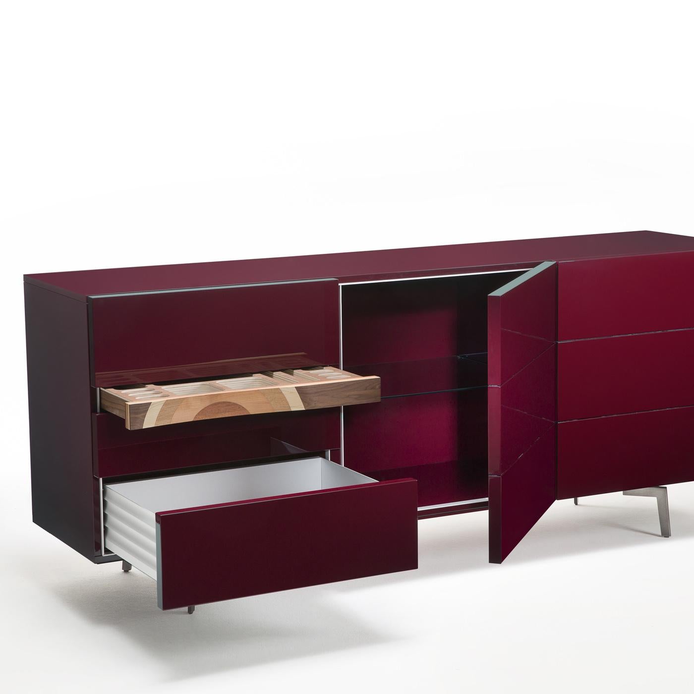 This simple and elegant sideboard by Toyo Ito is enriched with a striking jewelry drawer made of five types of wood (mahogany, oak, cherry, walnut, and ash), that echoes the look of the Ripples Bench. The frame, doors and other six drawers are made