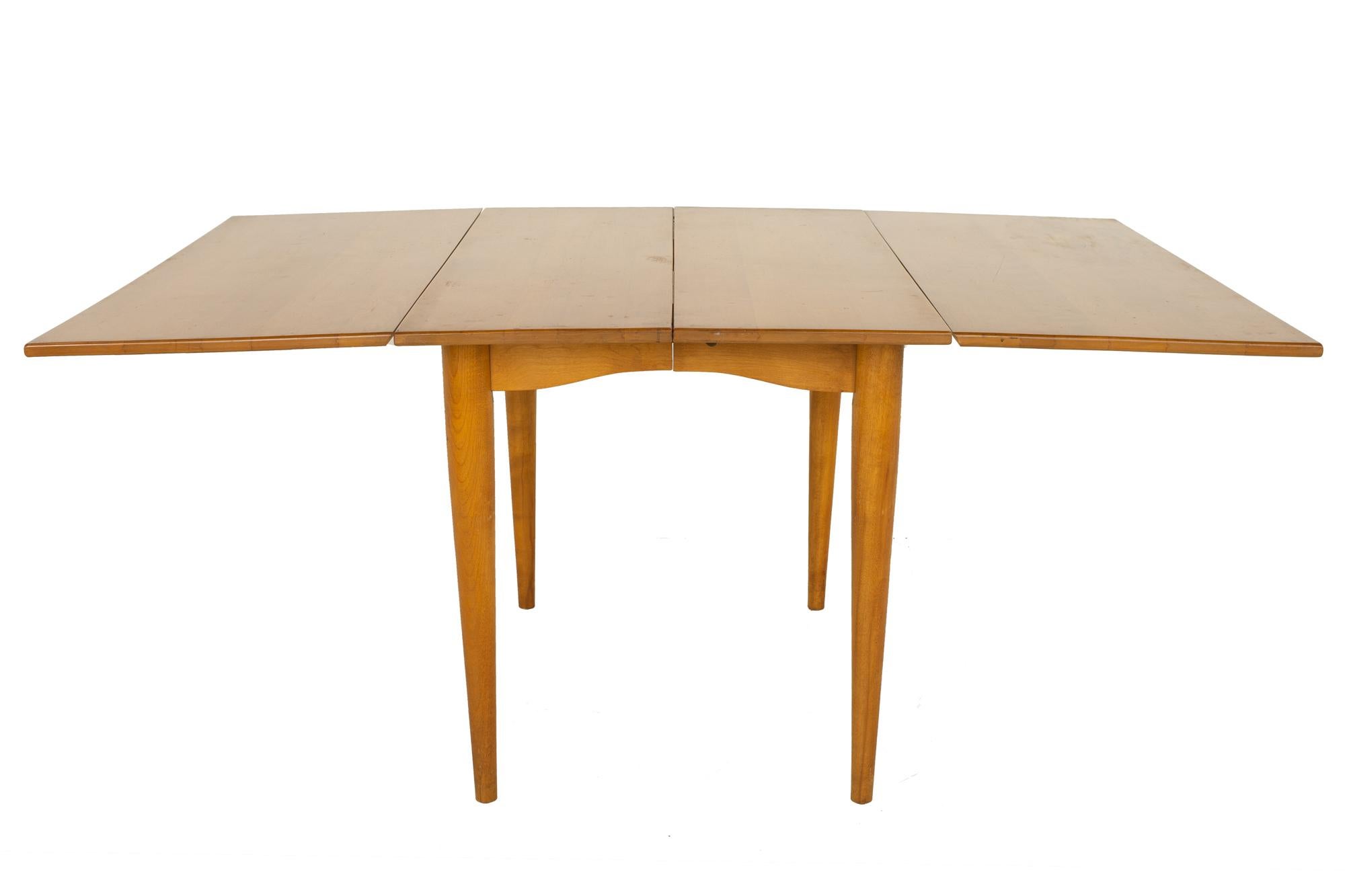 Conant Ball mid century drop leaf maple dining table with 2 leaves

Table measures: 66.25 wide x 42 deep x 29.25 inches high, with a chair clearance of 25 inches

?All pieces of furniture can be had in what we call restored vintage condition.