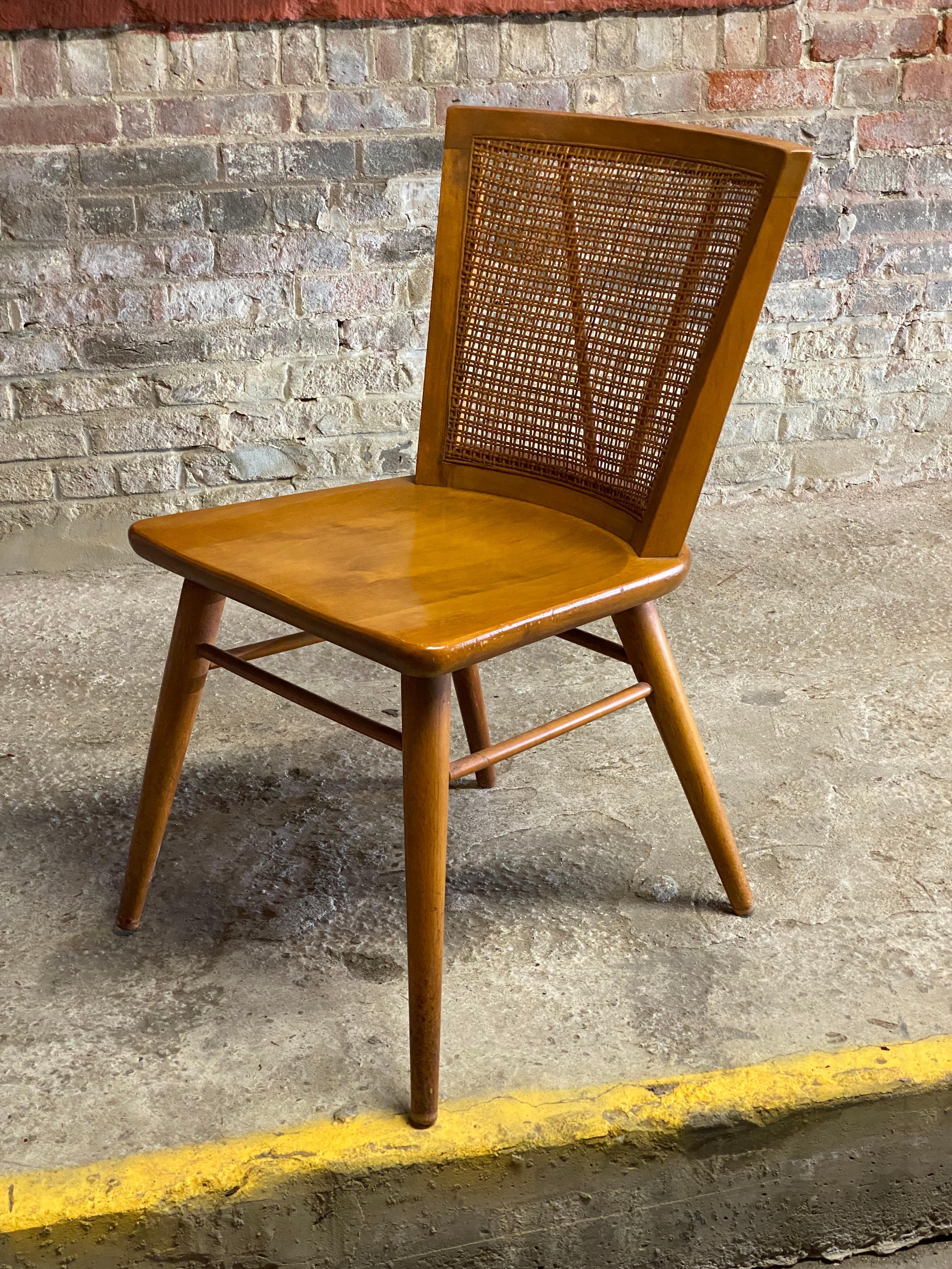 Solid maple and cane back side chair designed by Leslie Diamond for Conant Ball. Good overall condition and structurally sound and sturdy construction. The chair features a very clean cane back with nicely tapered legs, stretcher base, contoured