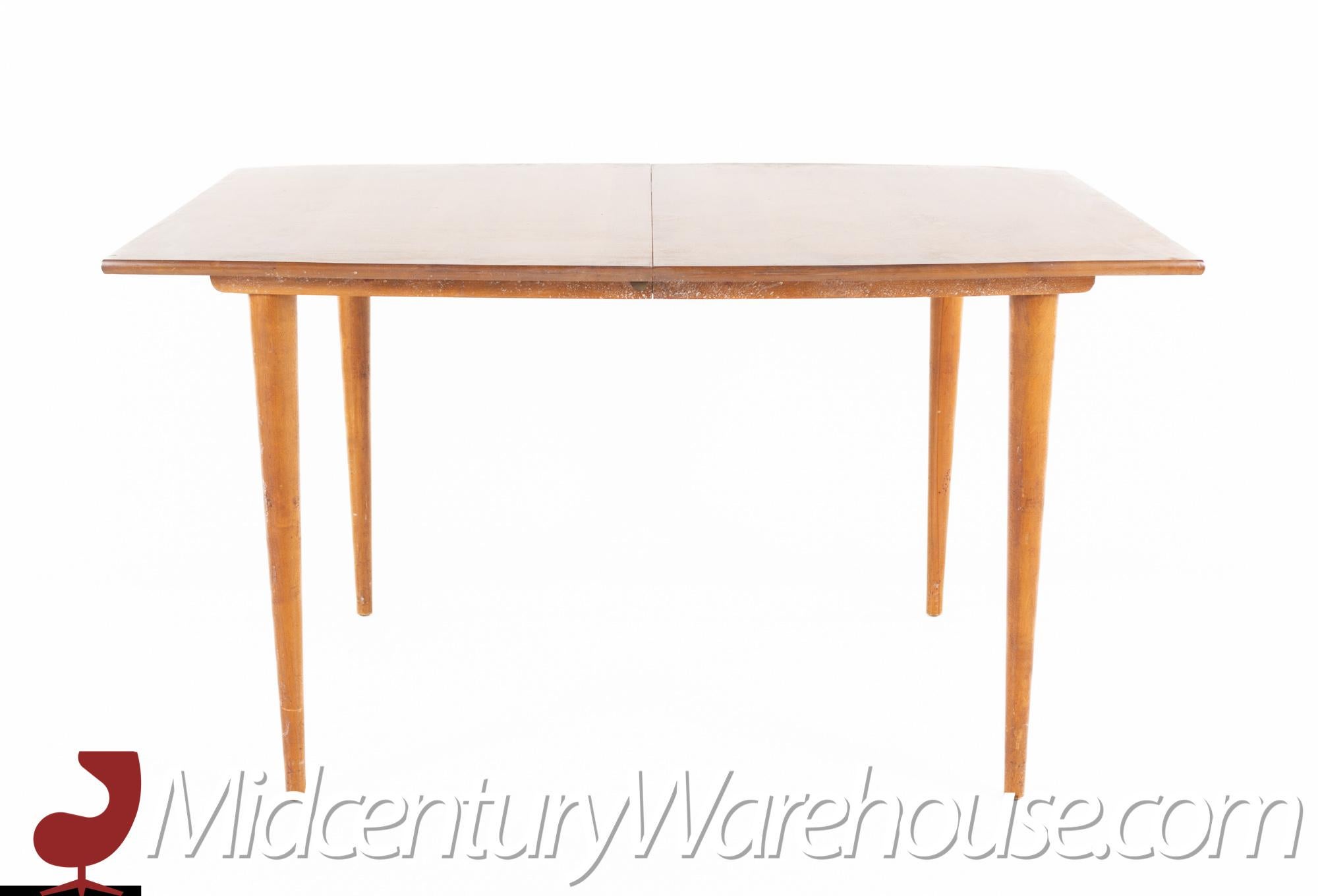 Conant Ball style mid century blond rectangular dining table with peg legs.

This table measures: 54 wide x 39 deep x 30.25 high, with a chair clearance of 28 inches.

All pieces of furniture can be had in what we call restored vintage