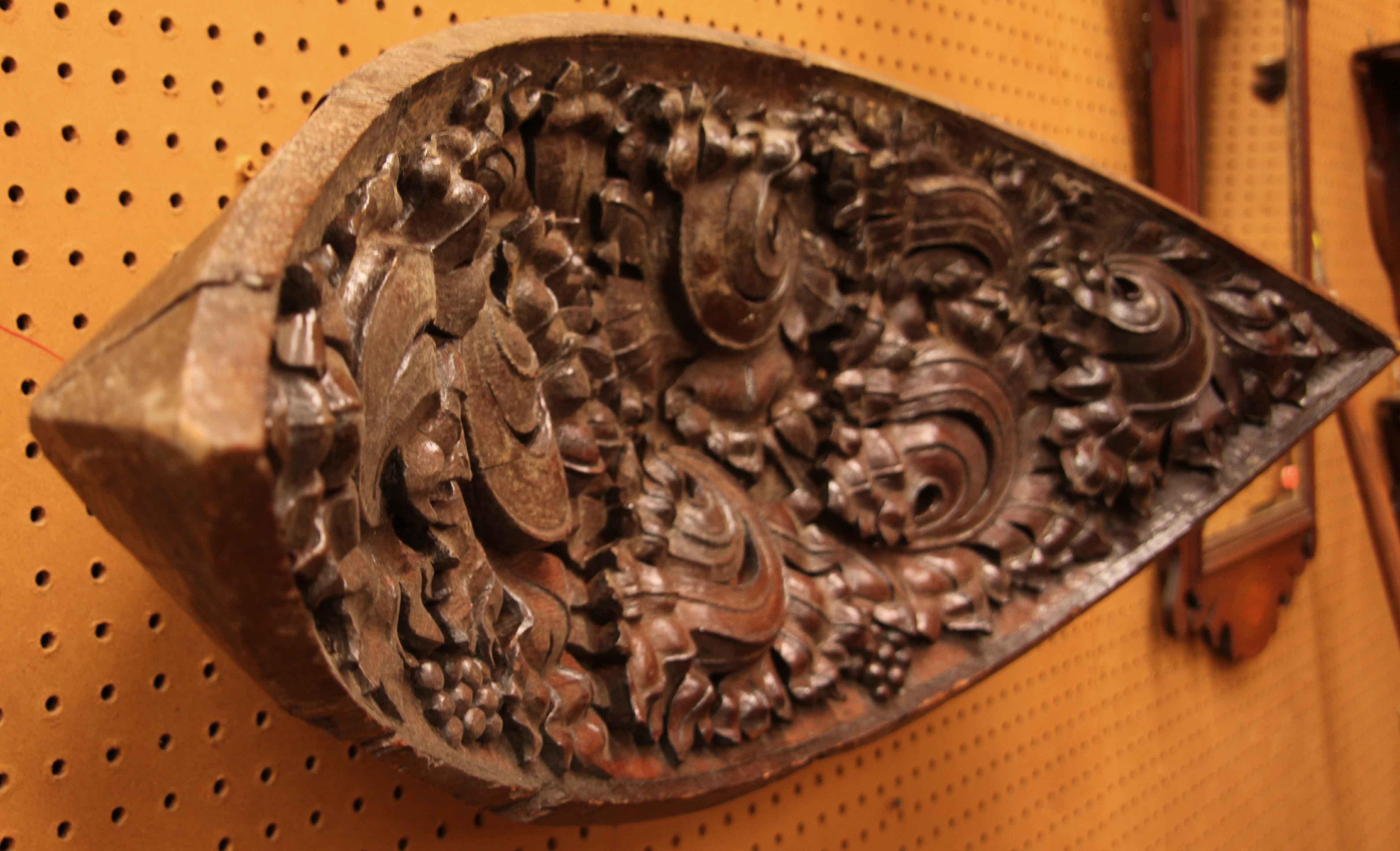 Concave shaped carving,  this unique piece can rest flat on a surface or hang ( it has 2 original attached rings on the back for hanging) .  The whimsical carving defies conventional descriptive terms, there does appear to be foliate and grapes in
