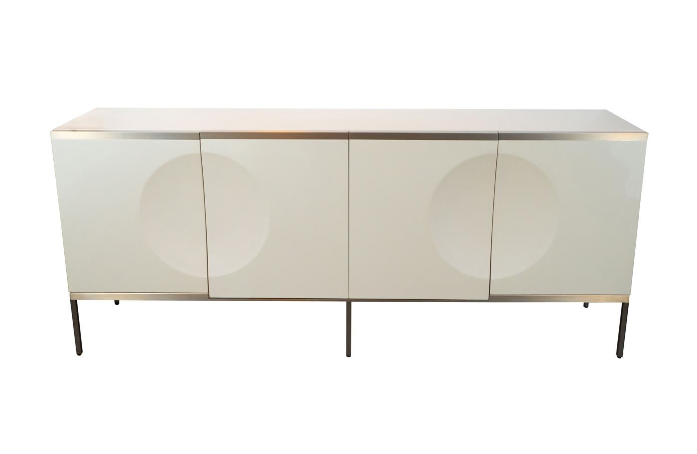 High gloss metallic lacquer with satin metallic concave circle details. Four doors with four adjustable shelves, light satin bronze base and details.