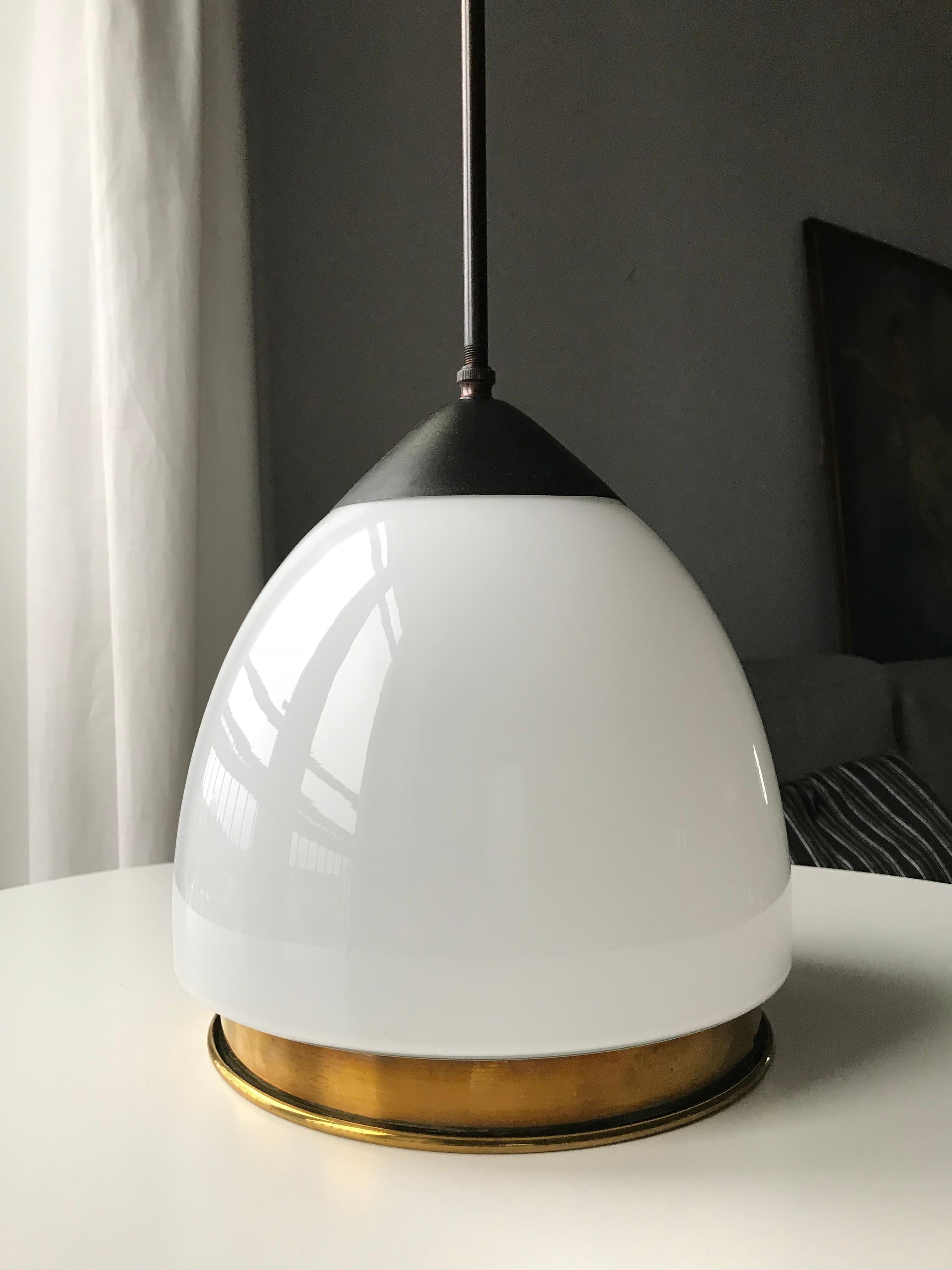 Danish late manufacturer Fog & Mørup Art Deco pendant. Black or dark brown patinated brass suspension. Very rare milky white opaline glass with concave bottom part and convex sides matching the glass holder. New black rounded wiring. Vintage