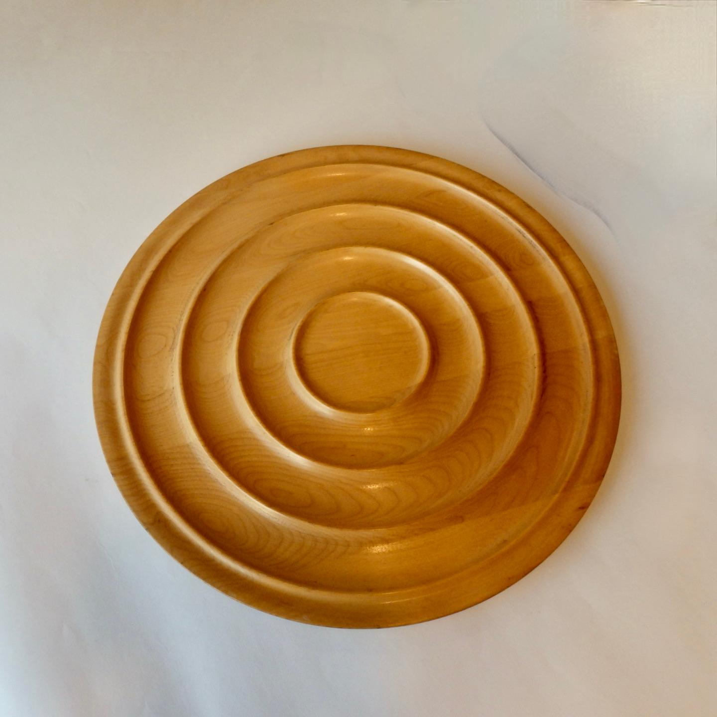 Nicely turned maple wood charger. Concentric ring design in the manner of Russel Wright.