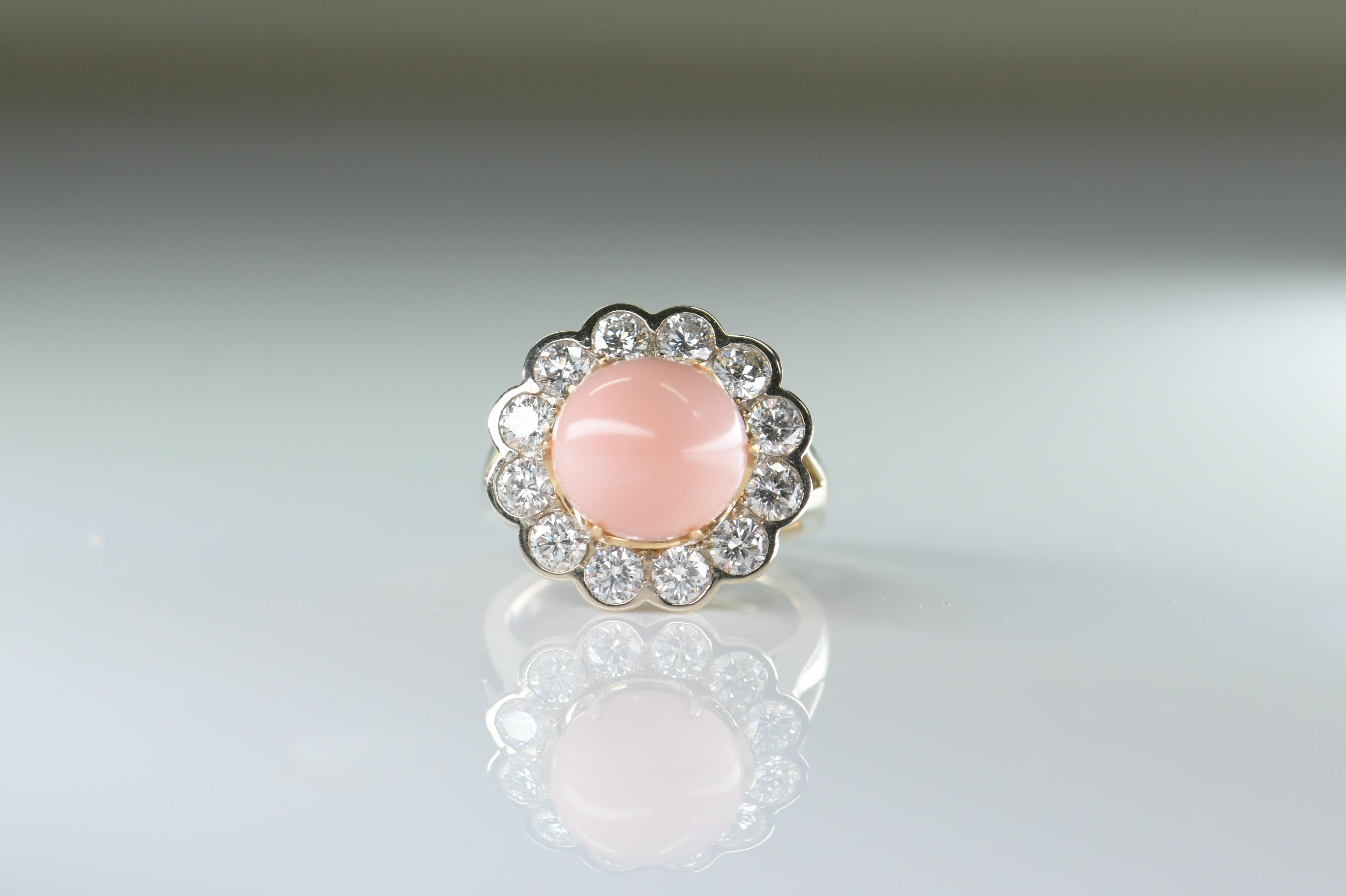 A gorgeous pink natural conch pearl is nestled in this classic Edwardian style halo mounting finely handcrafted over 18K yellow gold and framed by 1.6 carat of sparkling round diamonds. Conch pearls are a very rare natural pearl from the Queen Conch