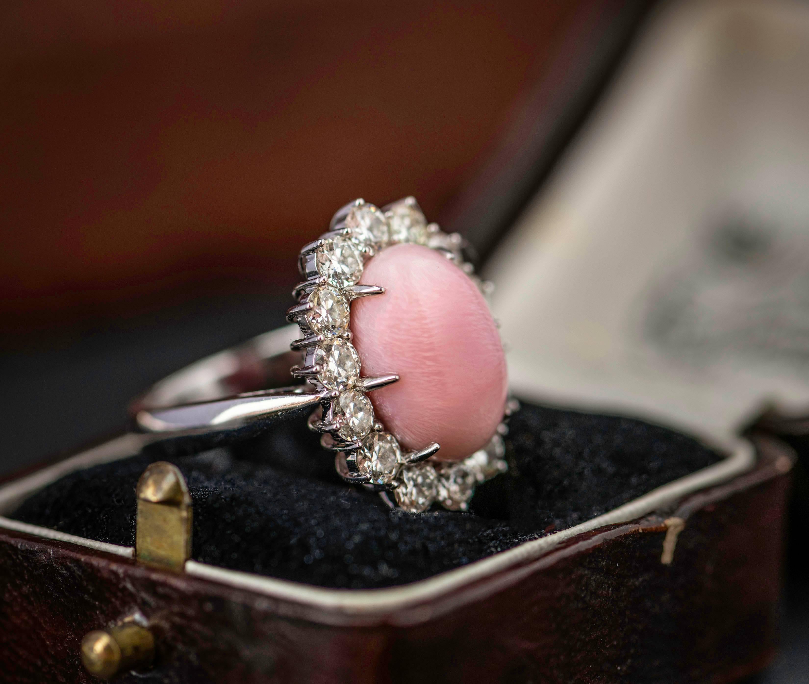 A classic design is considered classic for a very good reason. Cluster rings have been used for hundreds of years to highlight a special central stone. Here the central stone is a beautiful pink conch pearl. Conch pearls are all different as the