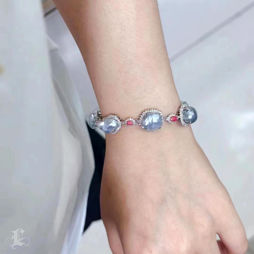 A rare fusion of nature’s finest treasures, this luxurious bracelet features large, luminous blue South Sea Keshi pearls—renowned for their aurora-like glow and organic, one-of-a-kind shapes. Each pearl is meticulously framed by a halo of 2.48