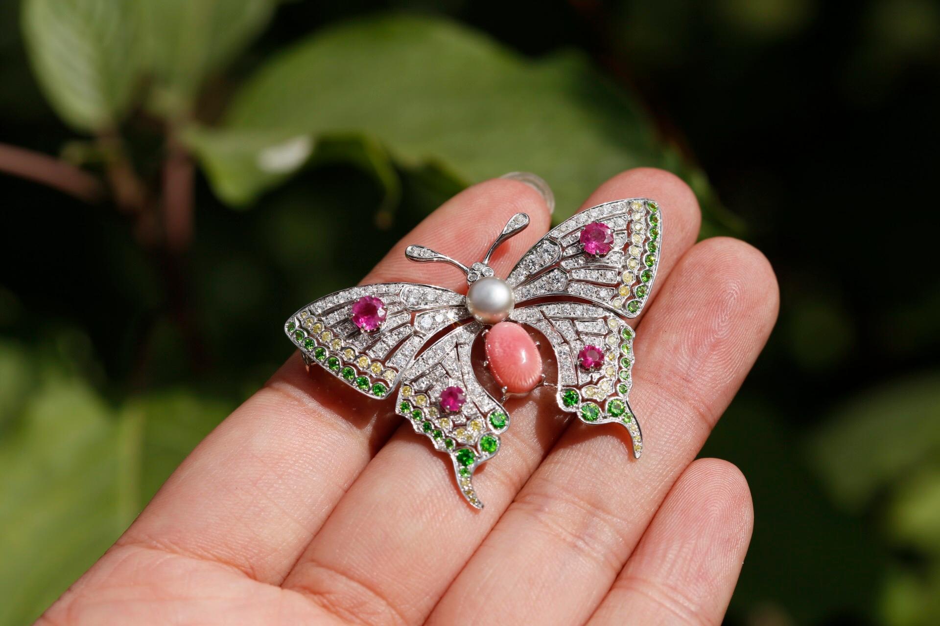 This delicately elegant brooch has so many stunning colours glistening, it has captured the natural beauty of a butterfly perfectly. 

At the centre of the brooch is a large conch pearl, as conch pearls are a natural form they differ in size, shape,