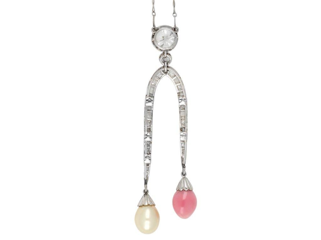 Conch Pearl, natural pearl and diamond necklace. Set with one drop shape natural conch pearl in a closed back part drilled setting, approximately 5.6-7.4 x 9.5-10.5mm and one drop shape natural saltwater pearl in a closed back part drilled setting,