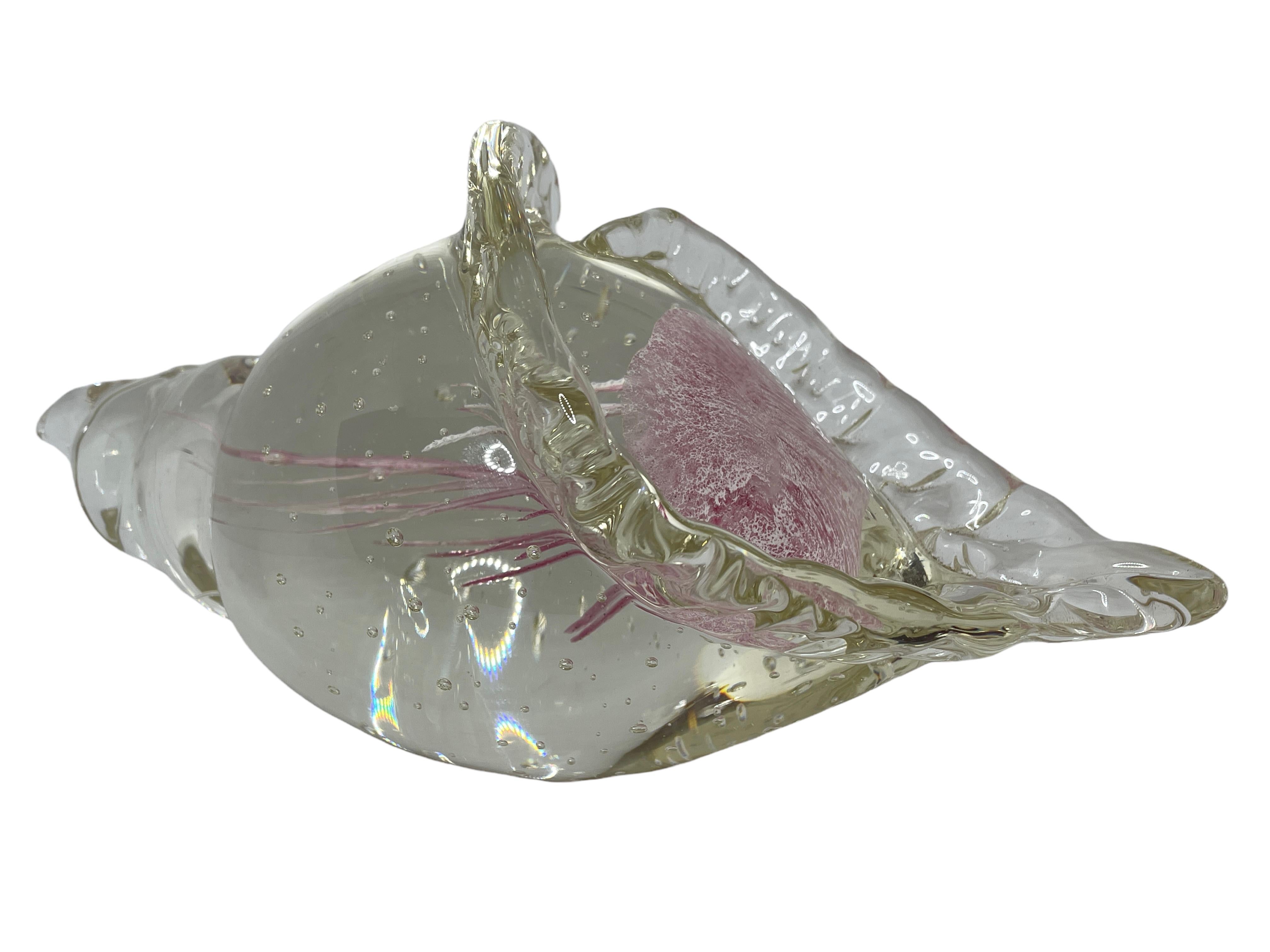 Beautiful Murano hand blown aquarium Italian art glass paper weight or statue. Showing a jellyfish, underwater floating on controlled bubbles in a conch shell. The color of the jellyfish is white and pink, the conch shell is in clear glass. A