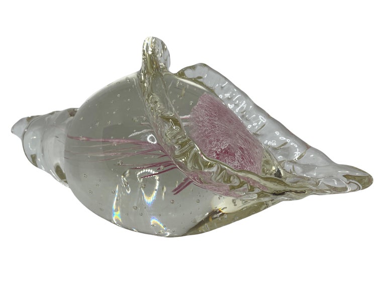 Beautiful Murano hand blown aquarium Italian art glass paper weight or statue. Showing a jelly fish, underwater floating on controlled bubbles in a conch shell. The color of the jelly fish is white and pink, the conch shell is in clear glass. A