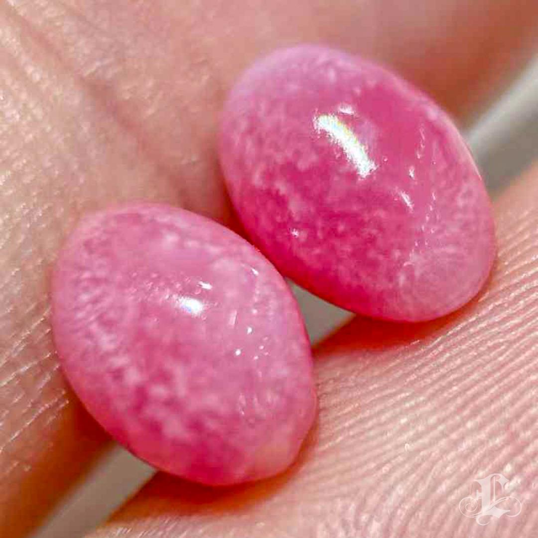 This rare pair of natural conch pearls features the highly sought-after Flamingo Pink hue, each exhibiting a vibrant and well-defined flame pattern. At 1.4 carats each, the pearls are remarkably matched in color, shape, and surface luster — a feat