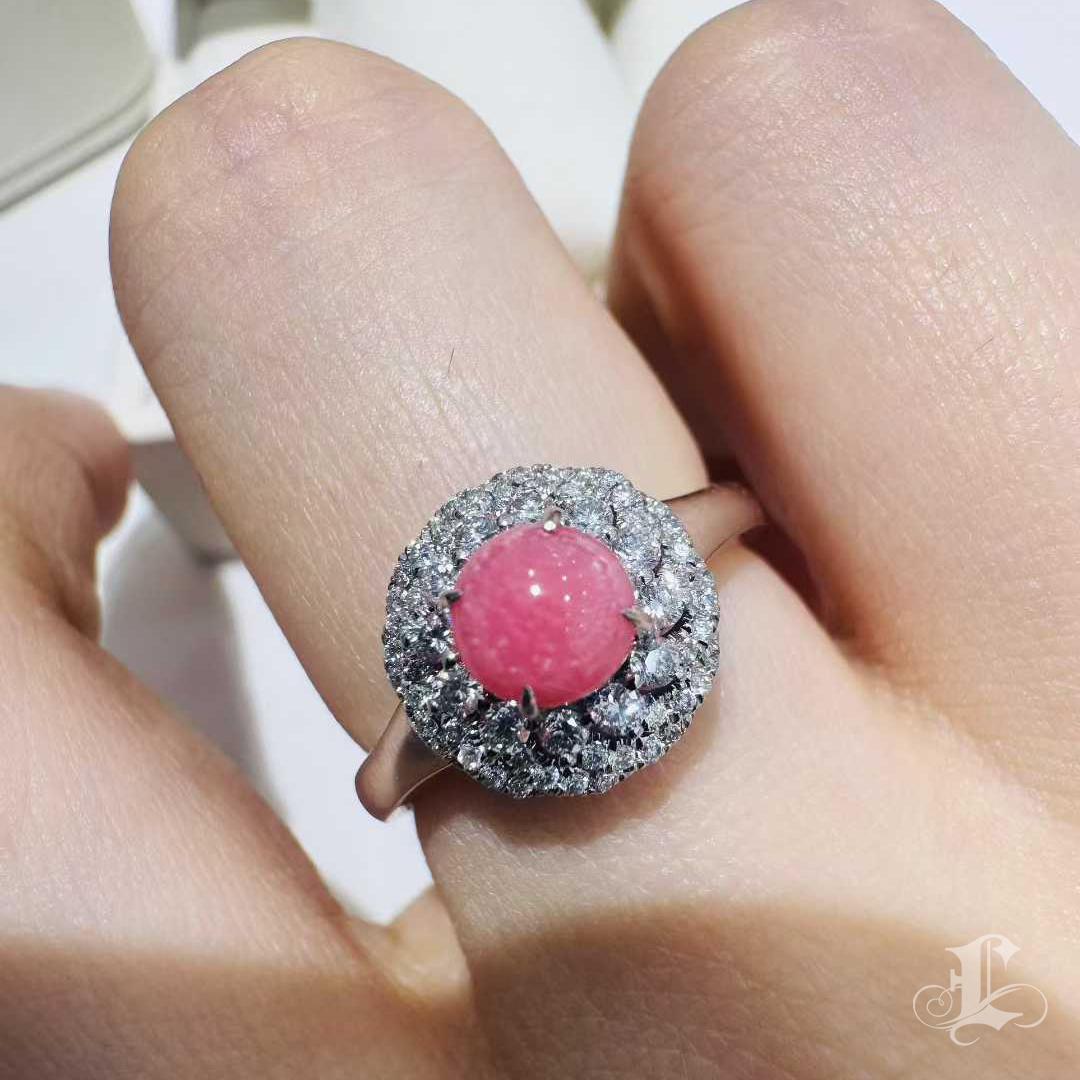 From the Conchéa Collection, this exceptional ring features a rare natural conch pearl weighing 0.87 carats, perfectly round and displaying a vibrant flamingo pink hue. Its surface is fully adorned with the signature flame pattern — a shimmering,