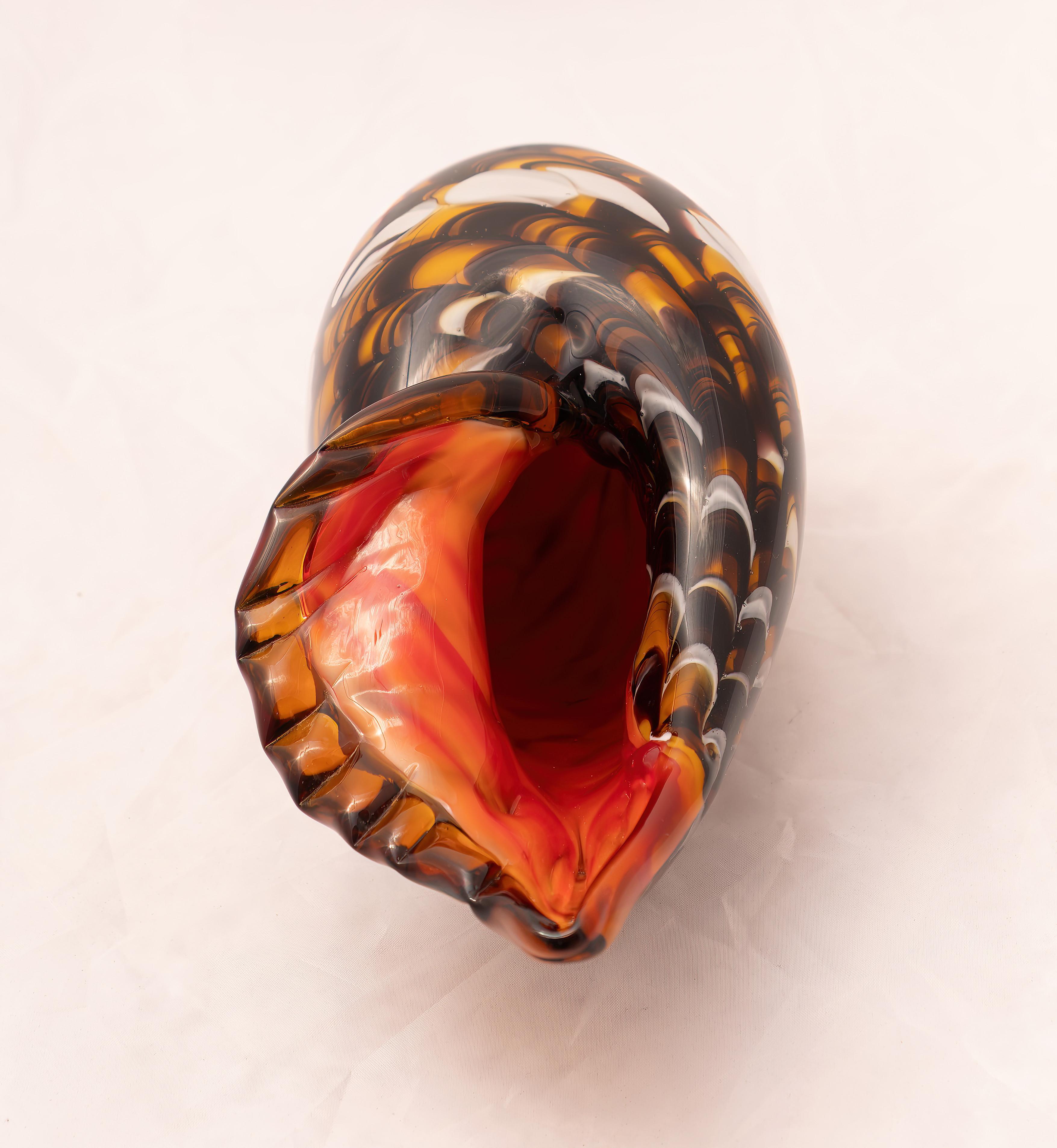 Murano glass furniture shell, Made in Italy, 1960s. 
Beautiful Murano glass shell made in the 1960s. It is made entirely of murano glass, shaped like an open shell on one. Its spiral shape is like that of a seashell. The shell is perfect for