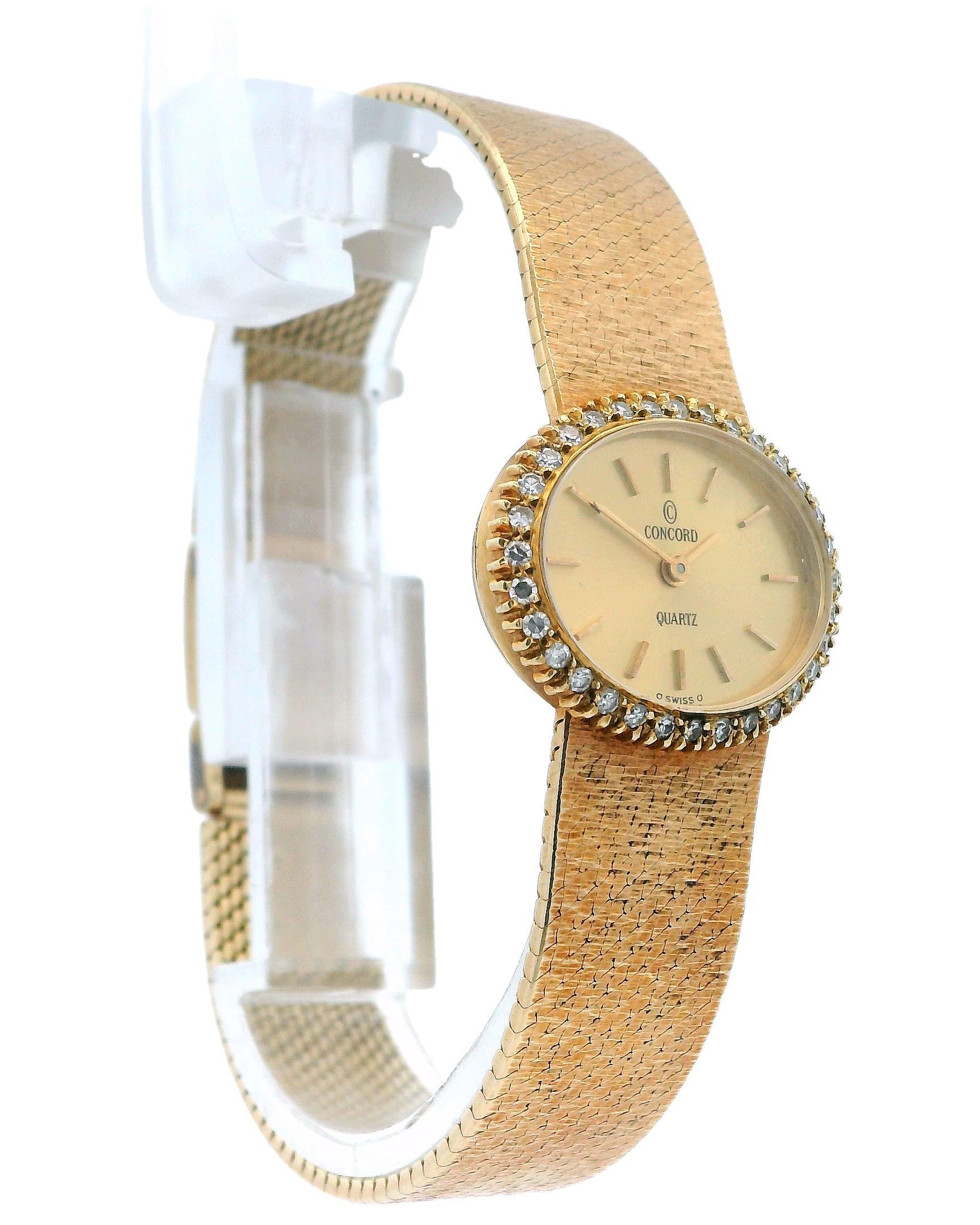 A luxurious Concord Watch.

This timepiece features an elegant oval shape with a quartz movement. The dial is a sophisticated champagne color, adorned with stick indexes. Surrounding the dial is a dazzling diamond bezel, adding a touch of