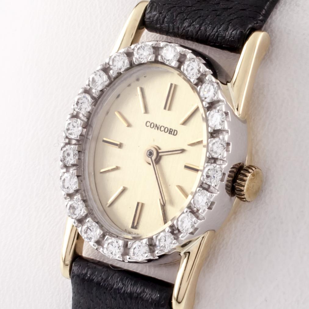 Round Cut Concord 14 Karat Gold Quartz Watch with Diamond Bezel and Leather Band