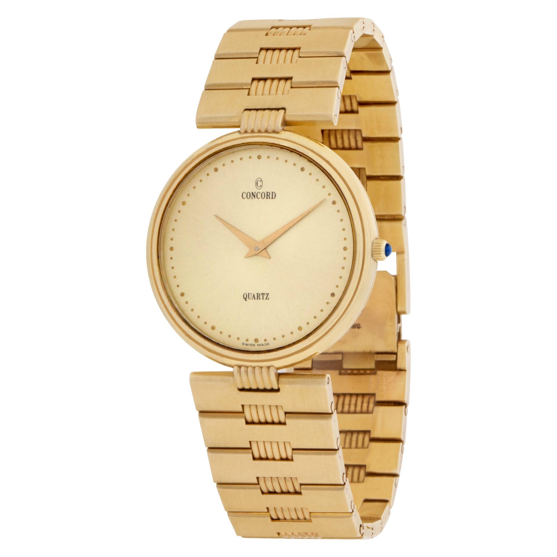 Concord Classic quartz watch in 14k with a champagne dial on 14k link bracelet. 34 mm case size. Fit for a 7.5'' wrist. Ref 2081215. Fine Pre-owned Concord Watch.  Certified preowned Classic Concord 2081215 watch is made out of yellow gold on a 14k